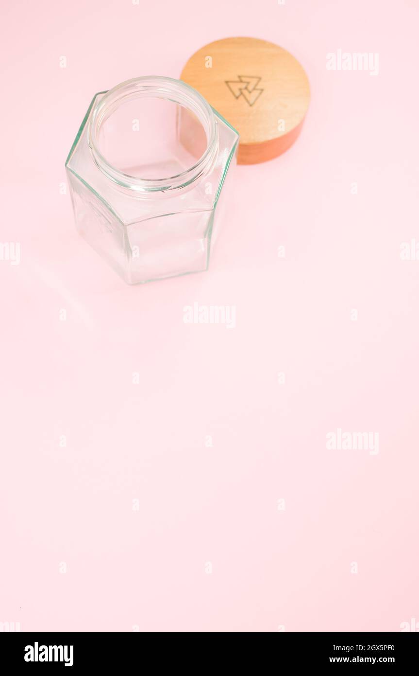 Empty glass jar with a wooden lid isolated on a pink background Stock ...
