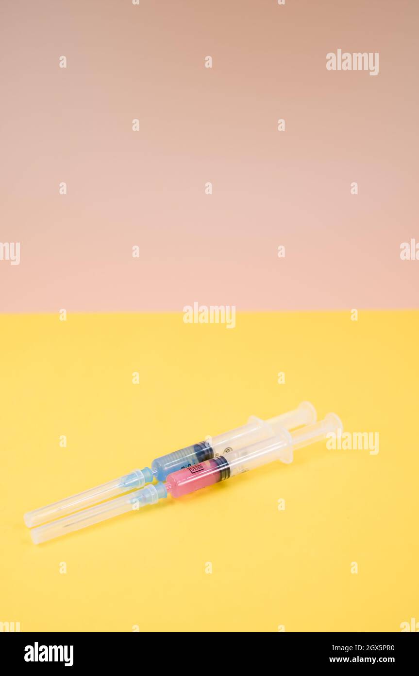isolated sterilized injection syringe on a yellow background Stock ...