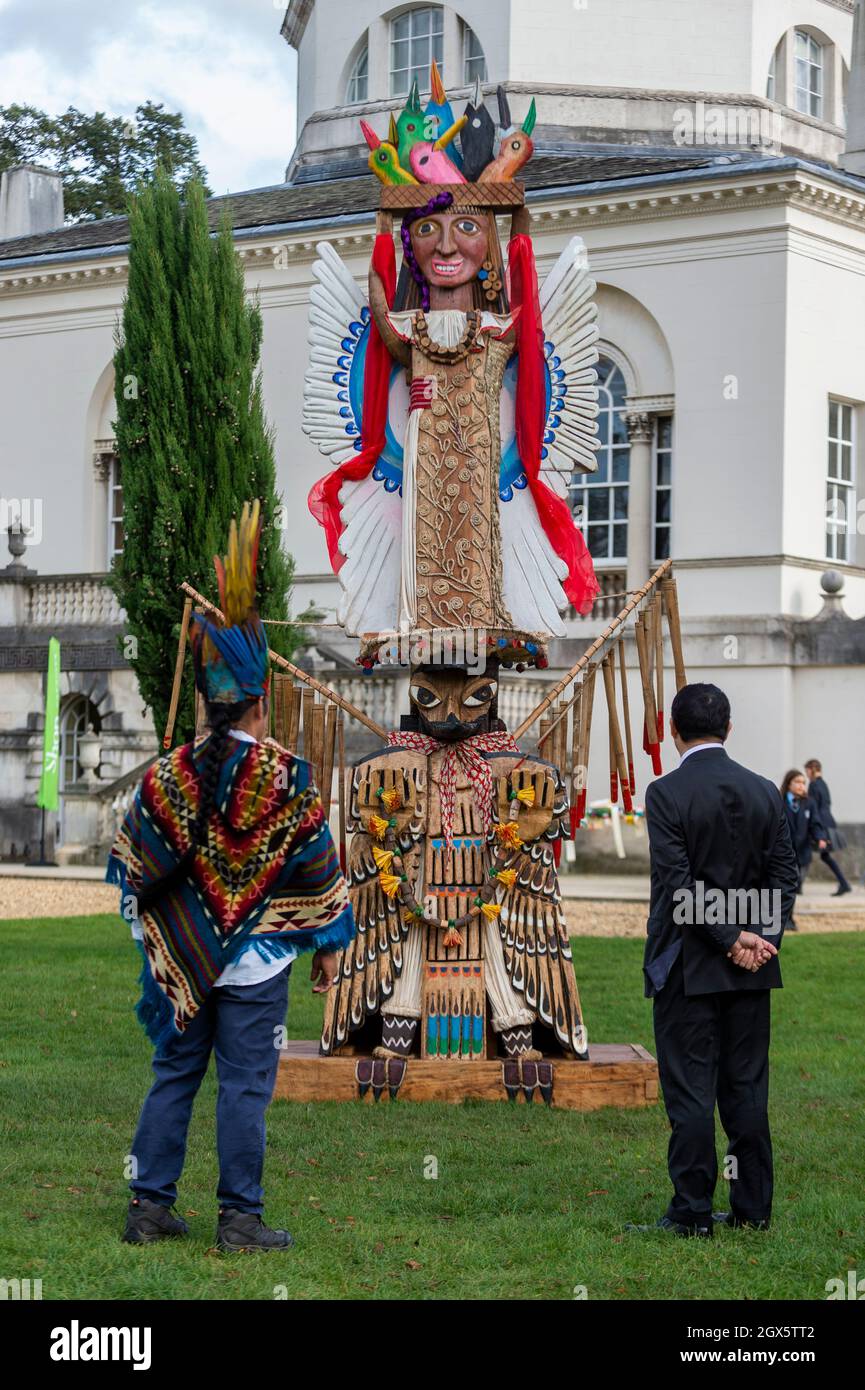 London, UK. 4 October 2021. Kurikindi, a shaman from Equador's Amazonian  rainforest, and Julian Juarez Cadenas, Deputy Head of Mission, at the  Embassy of Mexico next to Totem Latamat, carved by the