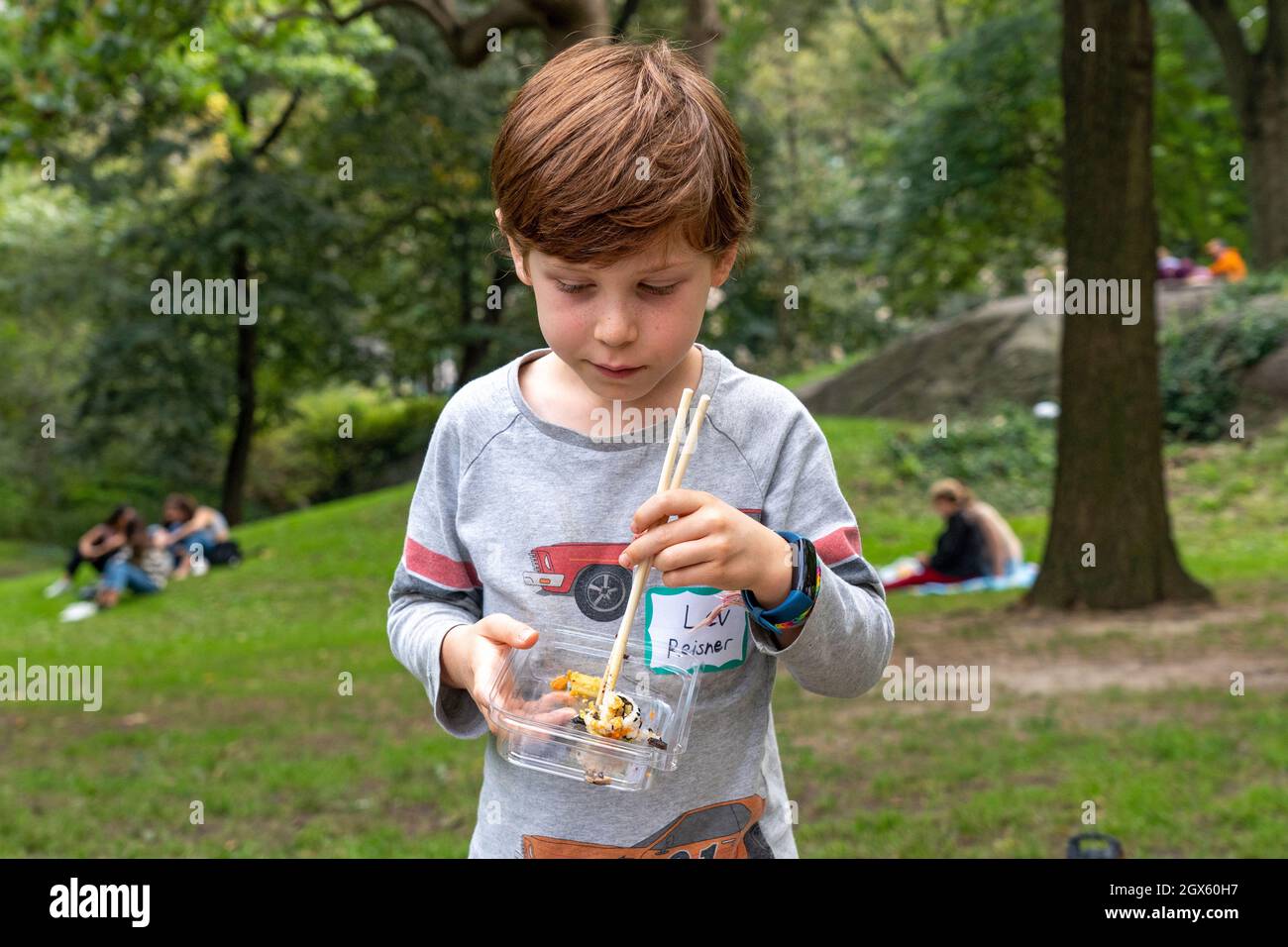 New York, United States. 03rd Oct, 2021. Lev, age 8, eats whole food, plant-based sushi at 'A whole food, plant-based diet is easier with support!' event in Central Park in New York City. Whole food, plant-based nutrition have been linked to a number of health benefits, including reducing risks and treating of heart disease, certain cancers, obesity, diabetes and cognitive decline. Credit: SOPA Images Limited/Alamy Live News Stock Photo