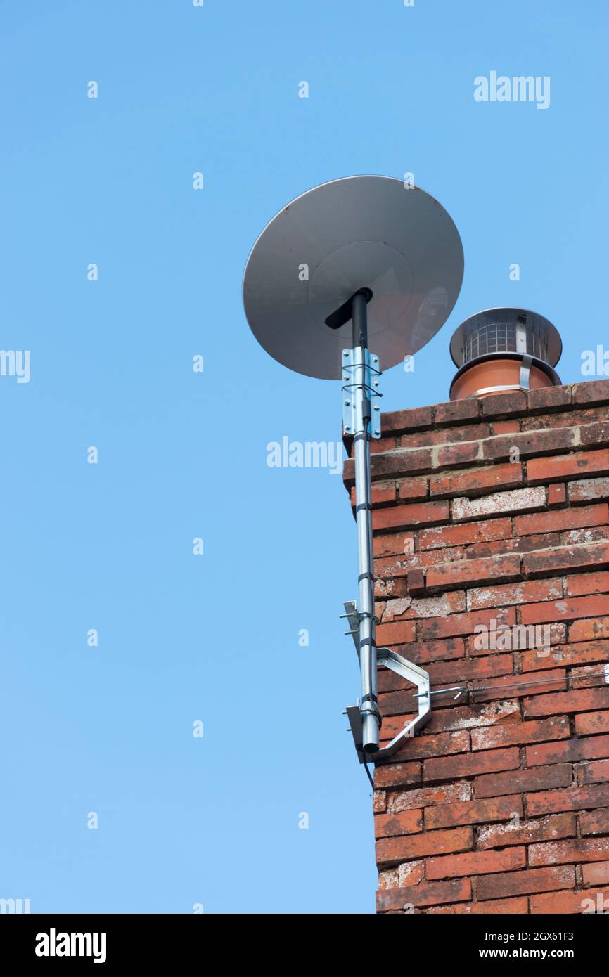 SpaceX Starlink satellite dish mounted on the chimney stack of a rural