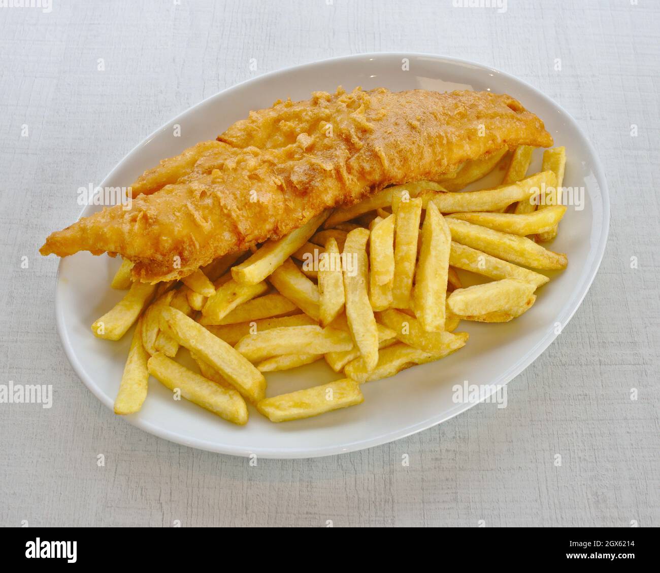 A plate of battered cod and chips Stock Photo