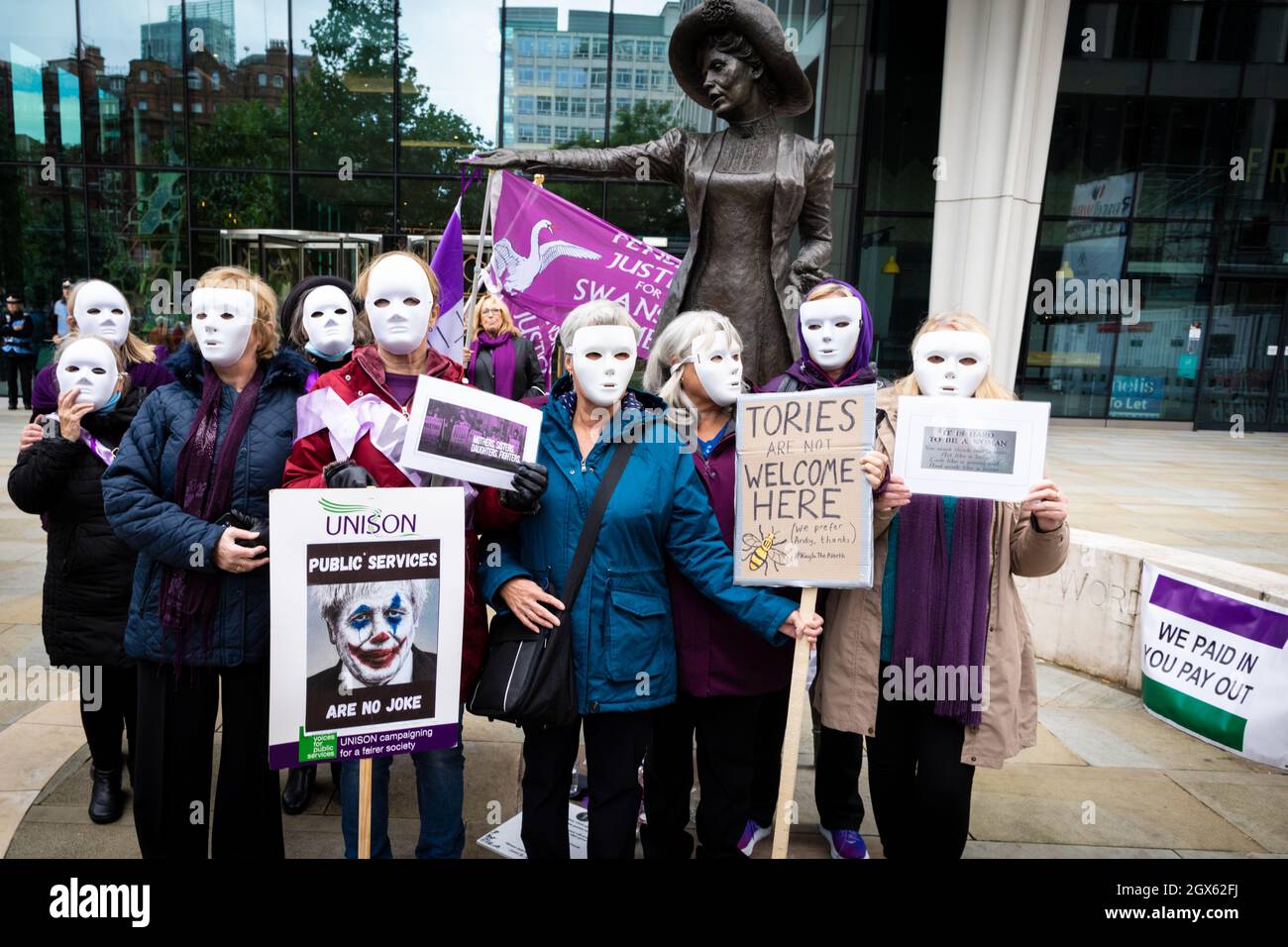 Manchester, UK. 04th Oct, 2021. People with placards attend the Women For State Pension Injustice Protest. People gather at the Emmeline Pankhurst statue in St Peters Square outside the Conservative Party Conference. The silent rally is a visual message to the government who appear reluctant to support the PHSOÕs findings of Maladministration.ÊAndy Barton/Alamy Live News Credit: Andy Barton/Alamy Live News Stock Photo