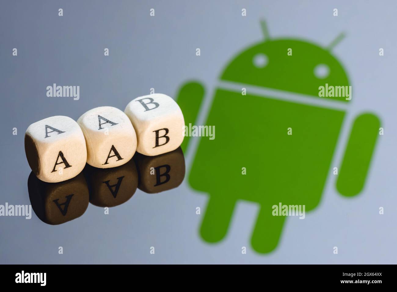 Abbreviation AAB(Android App Bundle) is made of cubes with letters. Android logo on the background. Stock Photo