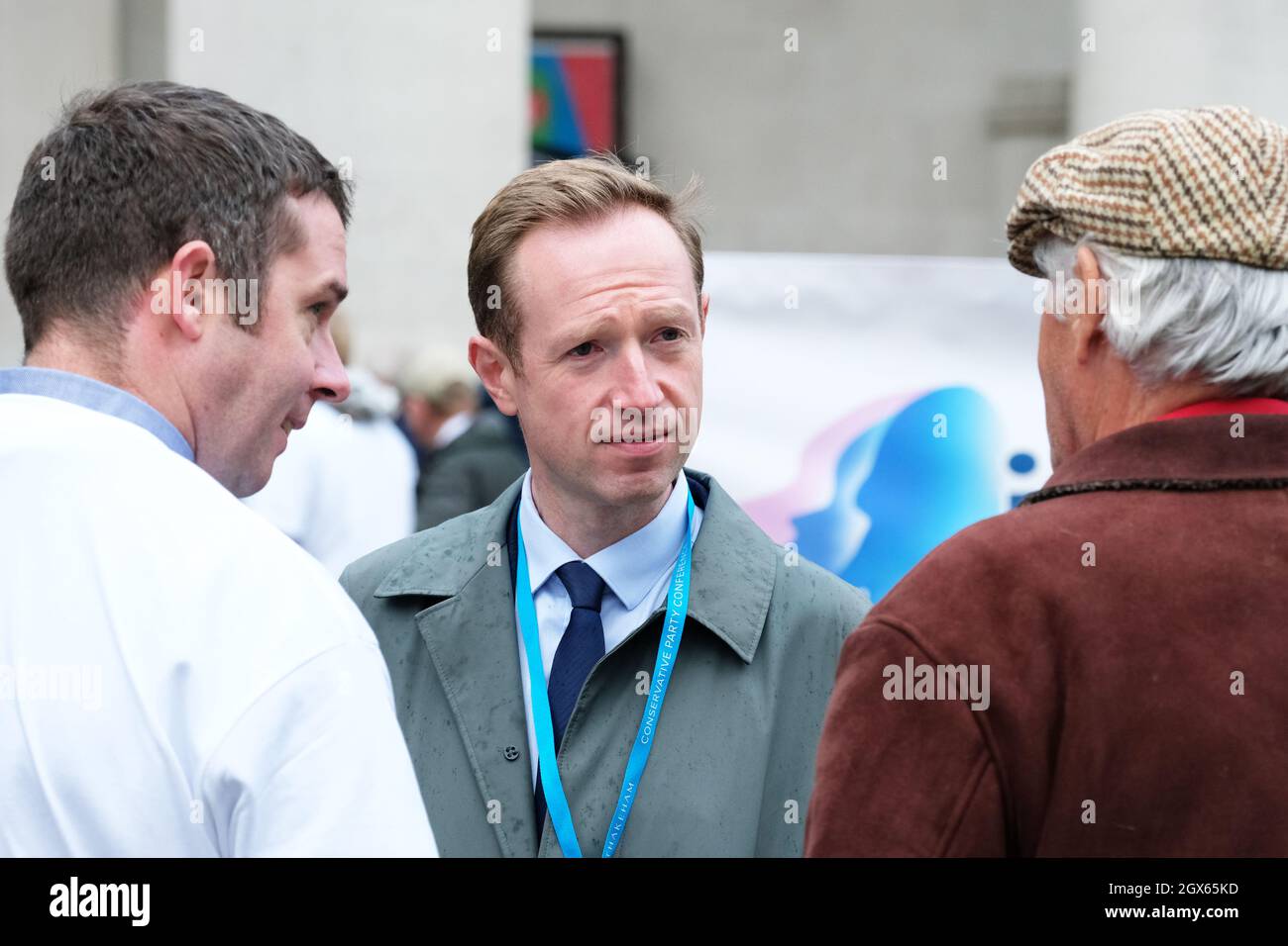 Manchester, UK – Monday 4th October 2021 – BBC News political correspondent Adam Fleming ( centre ) outside the Conservative Party Conference in Manchester talking with pork producers. Photo Steven May / Alamy Live News Stock Photo