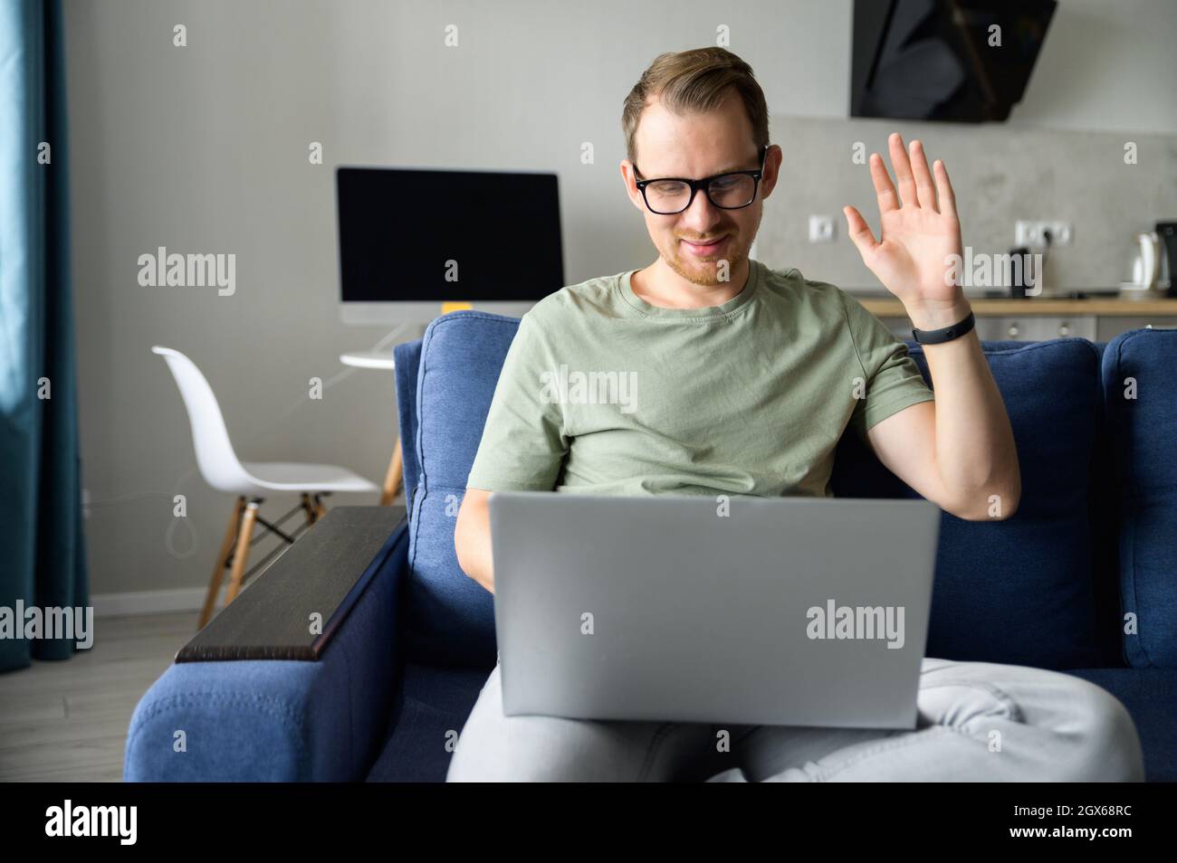 Young freelancer man wearing glasses using laptop computer for ...