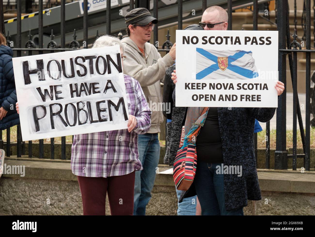 Halifax, Nova Scotia, Canada. October 4, 2021. Group of people gathered in front of the Provincial Legislature to protest the first day of the provincial vaccine mandate. The so called “Scotia Pass”, comes into force today requiring individuals to show proof of vaccination, in order to participate in non-essential events and activities that gather people together, such as going to restaurants, sports events, social events, and the gym. In next phase, most public employees will be required to show proof at their place of employment by November 30th. Stock Photo