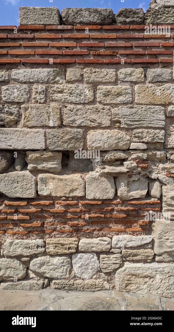 stone wall. red brick and large white stone. fragment of an ancient castle Stock Photo