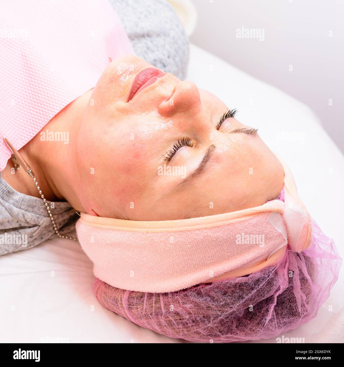 Steaming the face to open pores, applying liquid cream to open pores