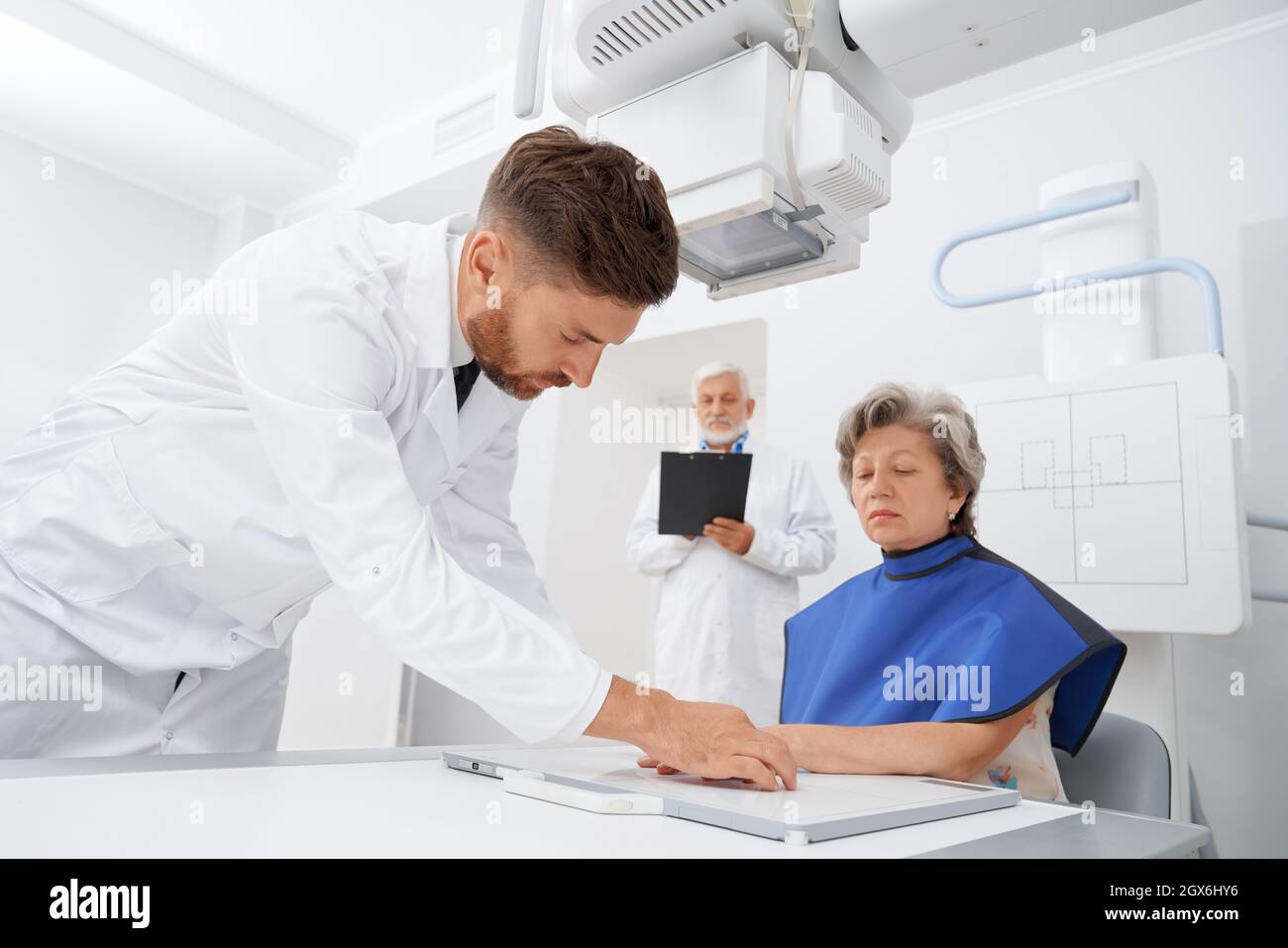 Professional radiologist put fingers of female patient on scanning area