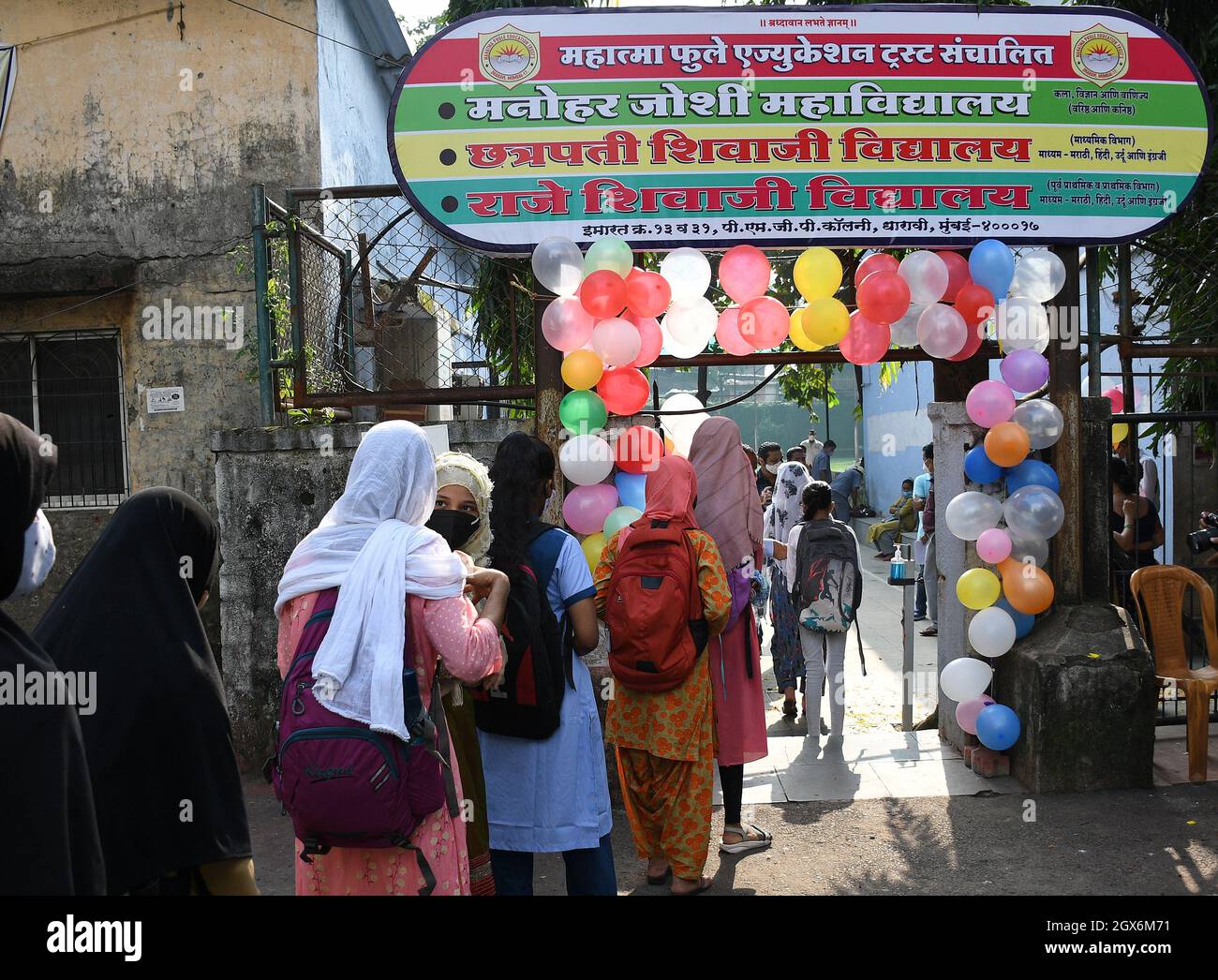 Mumbai, India. 04th Oct, 2021. Students wait near the gate of Chhatrapati Shivaji Vidyalaya school during the school reopening.Schools in Mumbai has reopened from 4th October after they were shut down due to the spread of corona virus disease. Credit: SOPA Images Limited/Alamy Live News Stock Photo