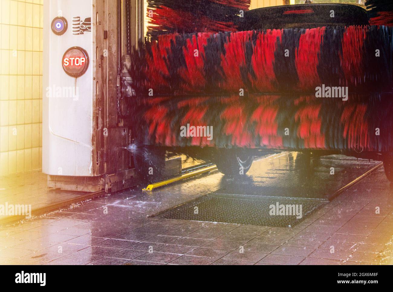 Automatic brush car wash in prozess, red and black brushes Stock Photo