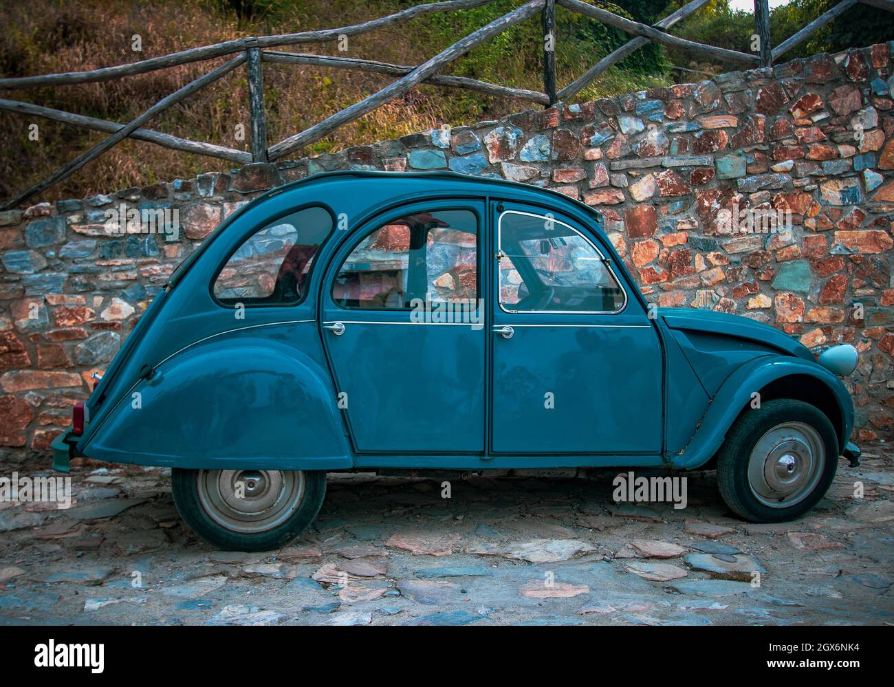 GREECE - AUGUST 16th, 2018: blue retro car Citroen 2CV on stone wall background Stock Photo