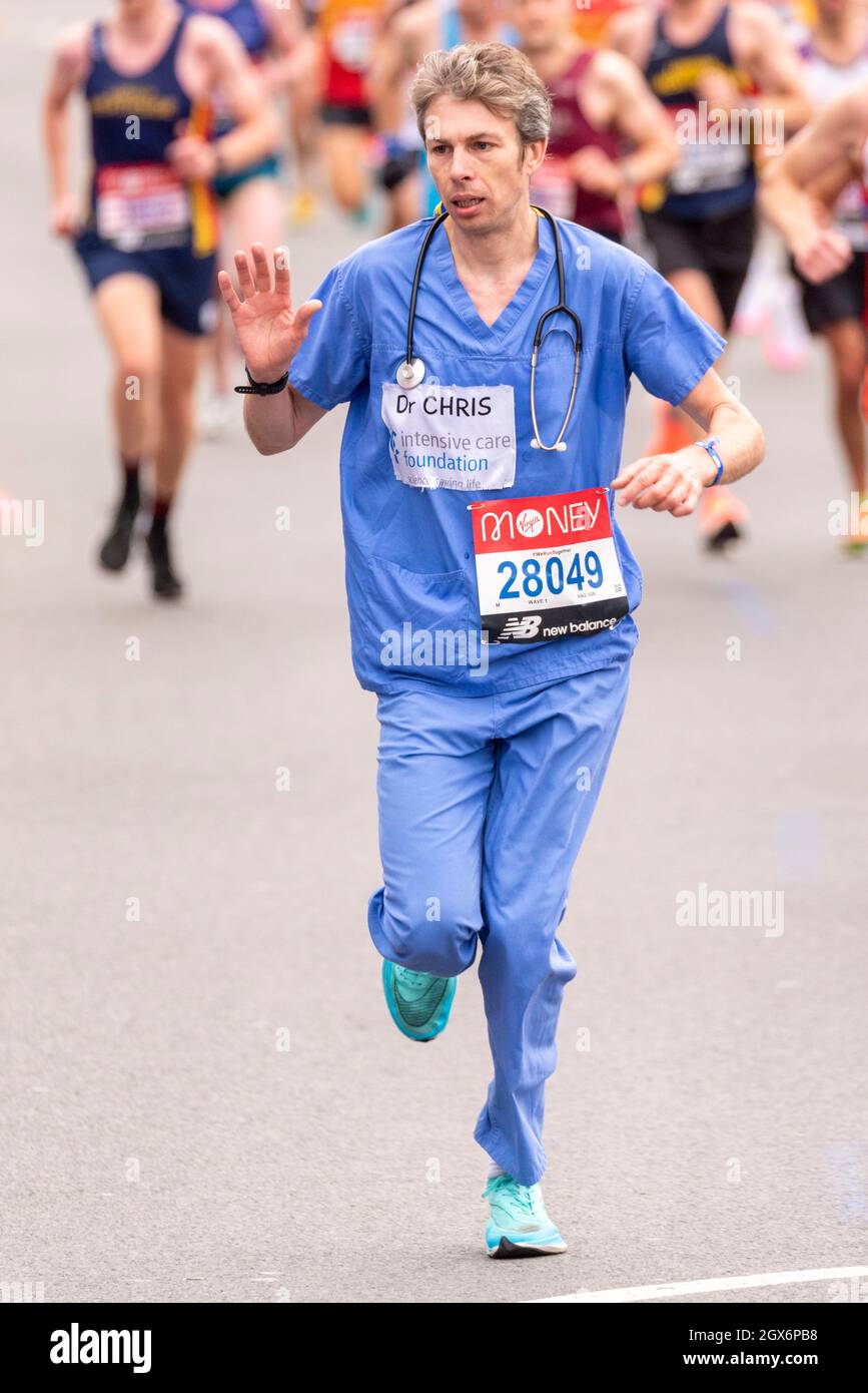 Dr, Chris Mason racing in the Virgin Money London Marathon 2021, in Tower  Hill, London, UK, in scrubs Stock Photo - Alamy