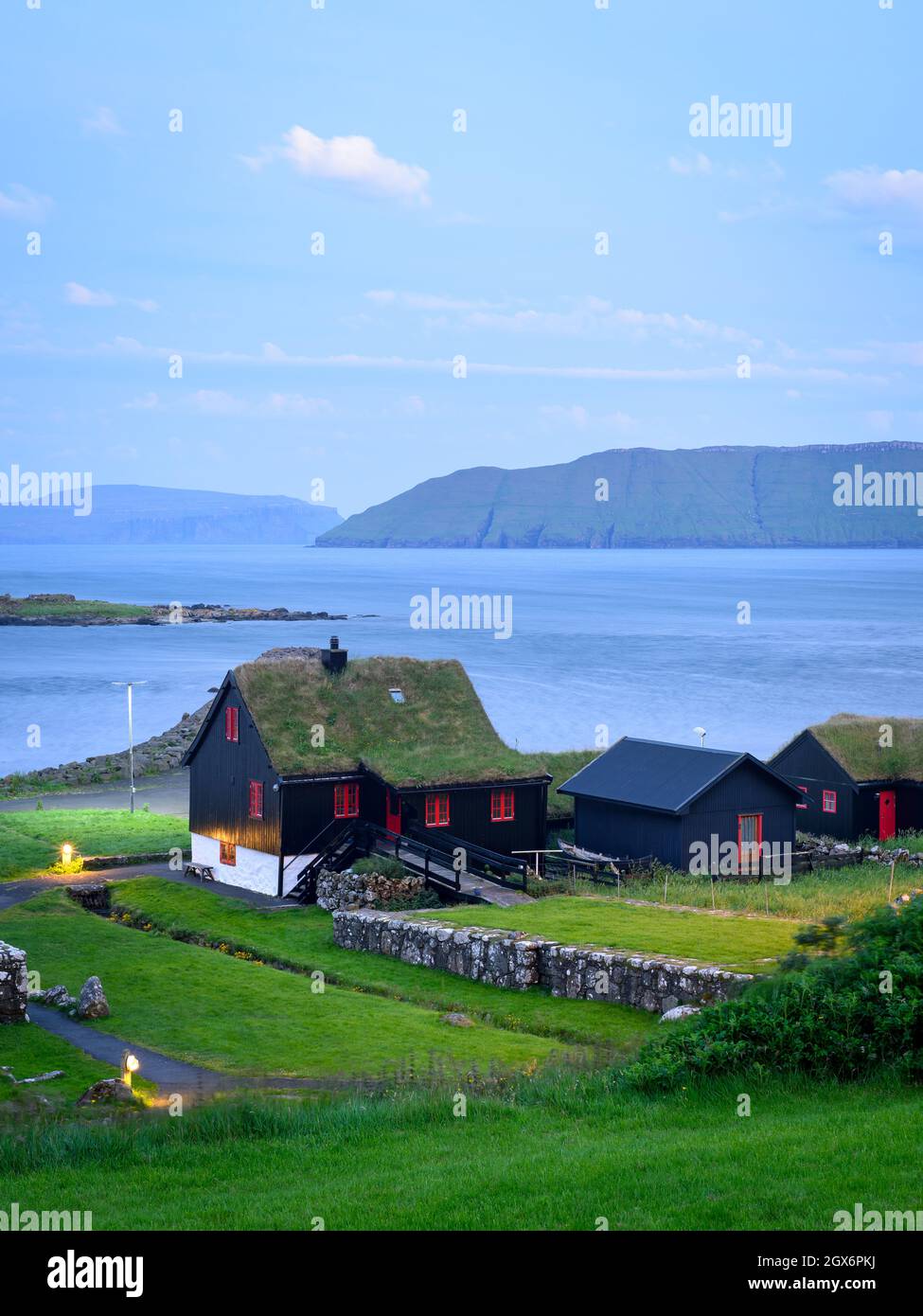 Kirkjubour village on Streymoy and has a view the islands of Sandoy and Hestur, Faroe Islands Stock Photo