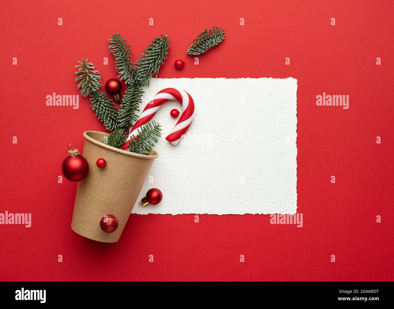 Christmas card with frame on red background and Christmas decorations. Flat lay, top view and copy space for text Stock Photo