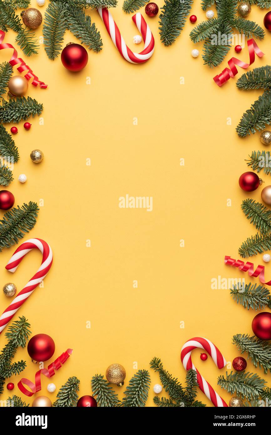 Christmas card with holiday frame on yellow background. Flat lay, top view and copy space for text Stock Photo