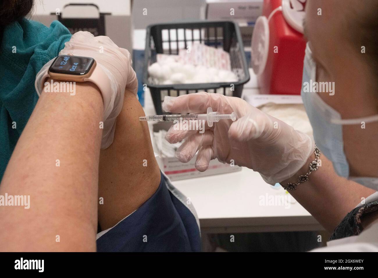 The booster shot for the Pfizer vaccine against COVID-19 is administered to a Texas resident over 65 at a pharmacy clinic in west Austin on October 4, 2021. Doctors are encouraging the vaccine boosters after 6 months of the original shots. Credit: Bob Daemmrich/Alamy Live News Stock Photo