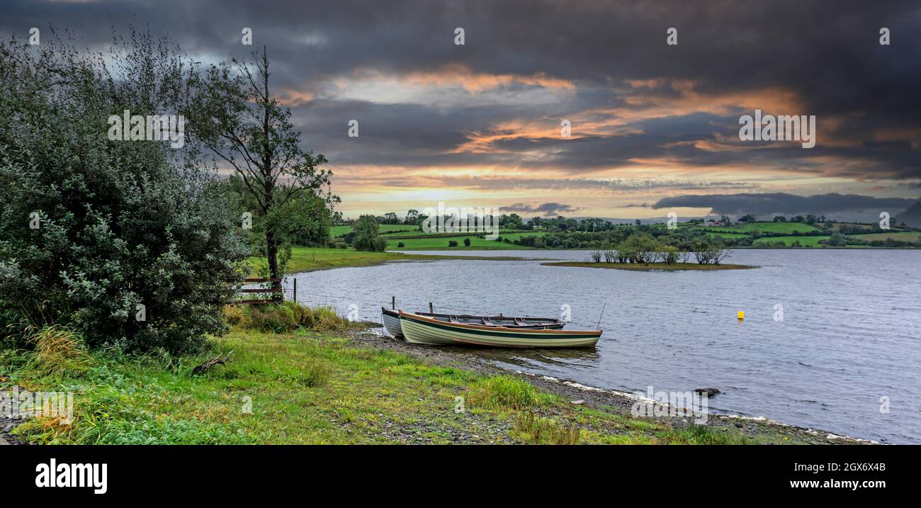 Lough Gowna in County Longford, Ireland. Two small boats tied up on Lough Gowna, a fresh water lake which is the uppermost lake on the River Erne. Stock Photo