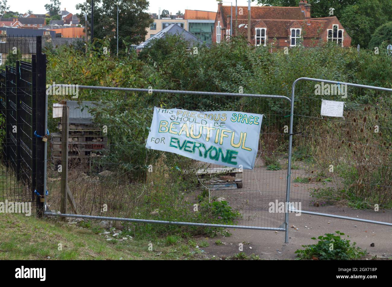 St Botolph's, Colchester, site of potential development into student accommodation. A banner has been hung on the fence in protest. Stock Photo