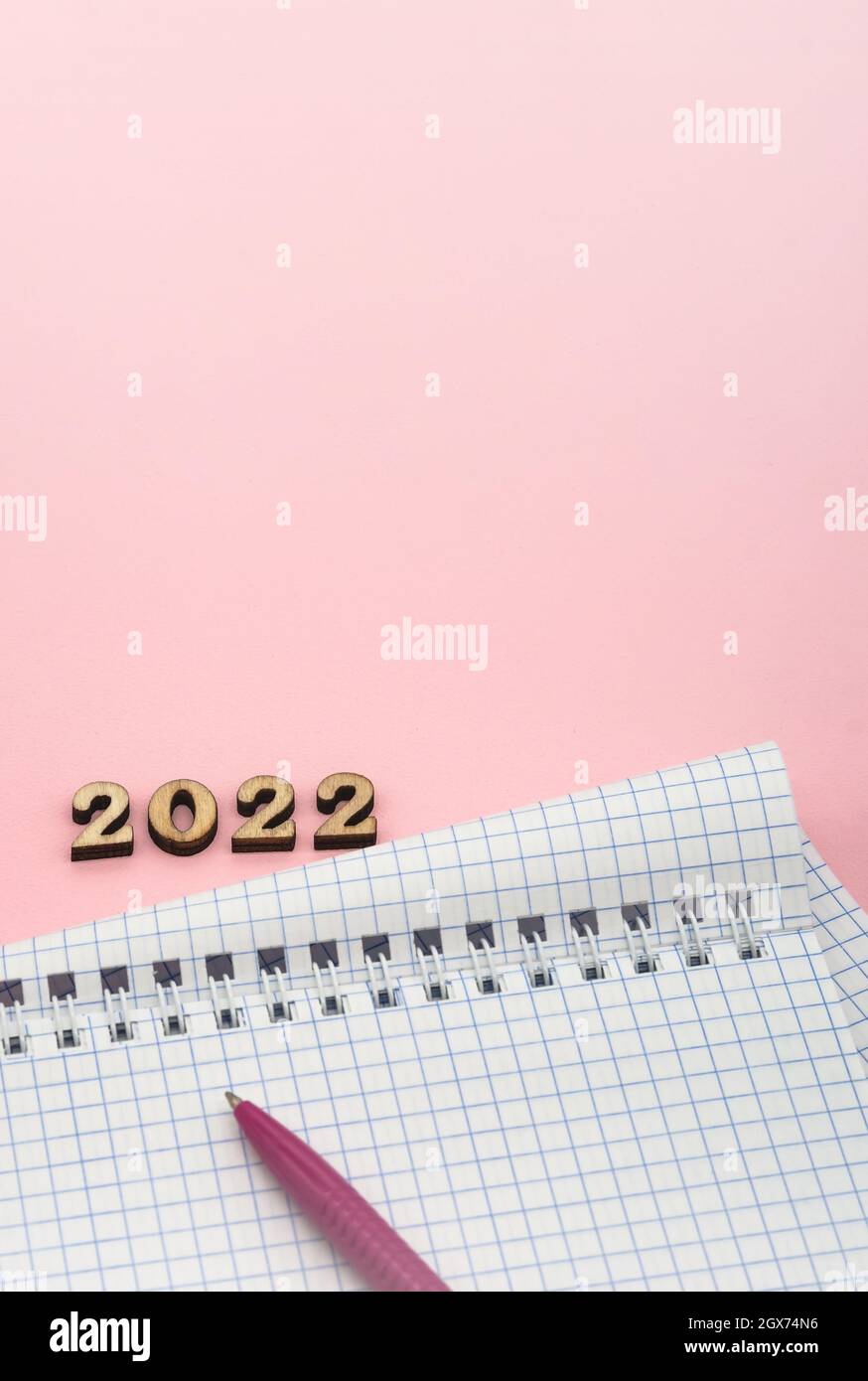 Wooden numbers 2022. Notepad on a spring. Notepad and Pen on Pink. Pink ...