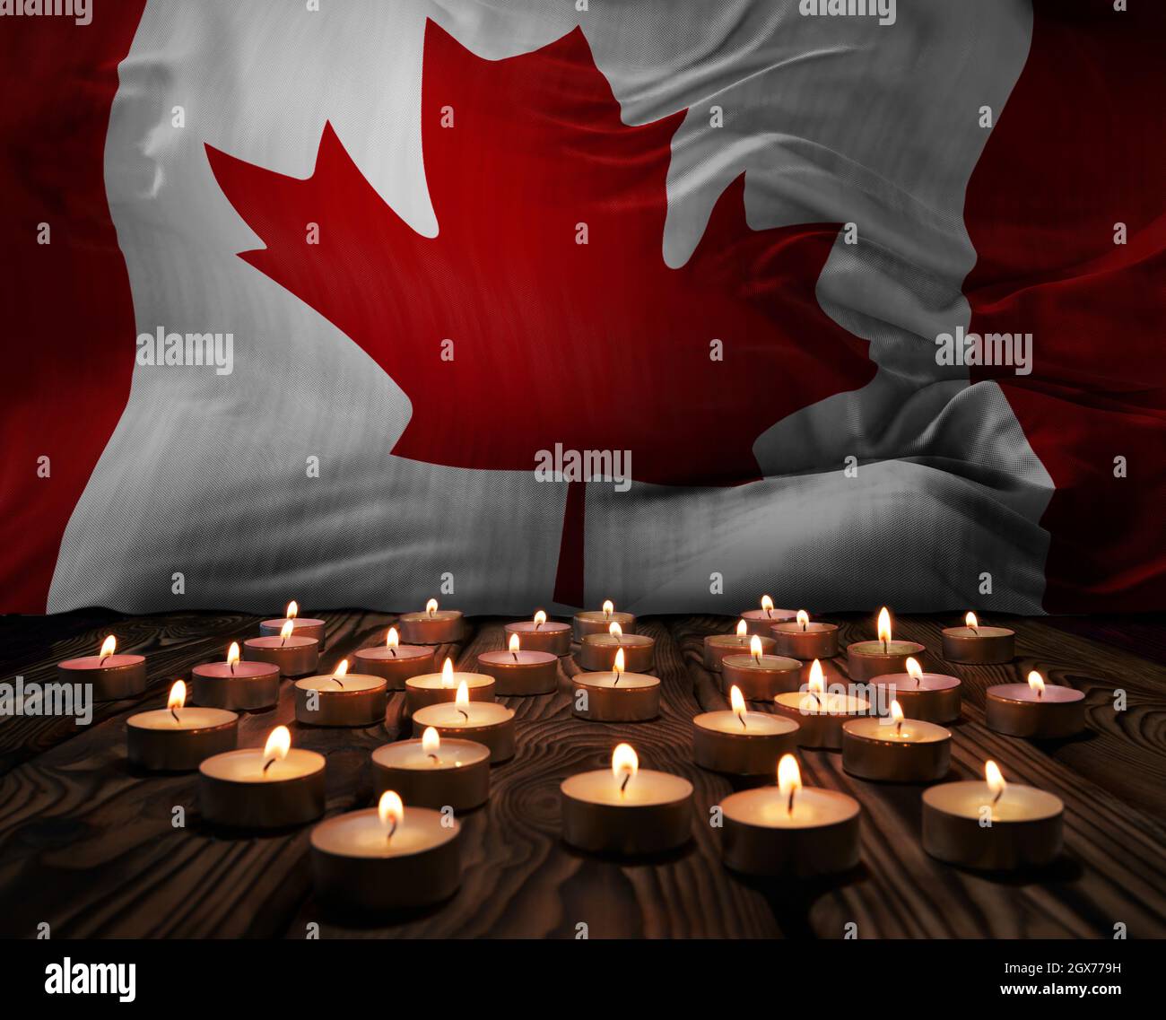 Mourning candles burning on Canada national flag of background