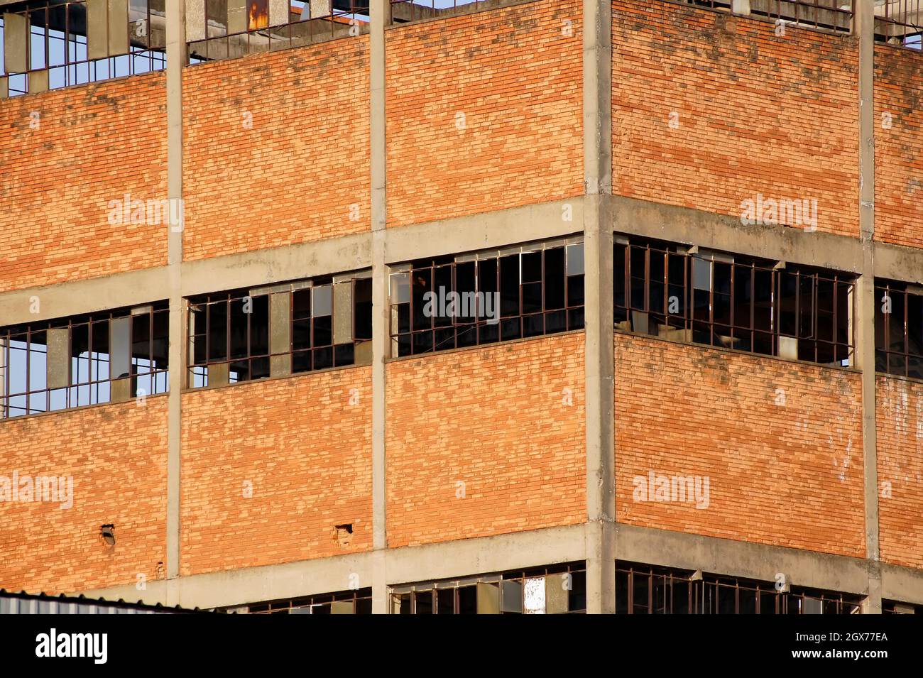 Old abandoned brick building with its broken glass windows Stock Photo ...