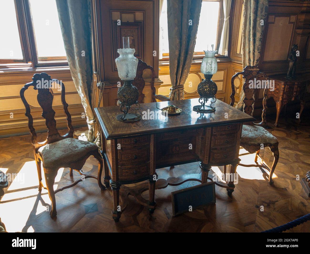 Writing desk with chairs and lamps inside the Miramare castle near Trieste. Interior design. Historical museum. 09-05-2021. Italy Stock Photo