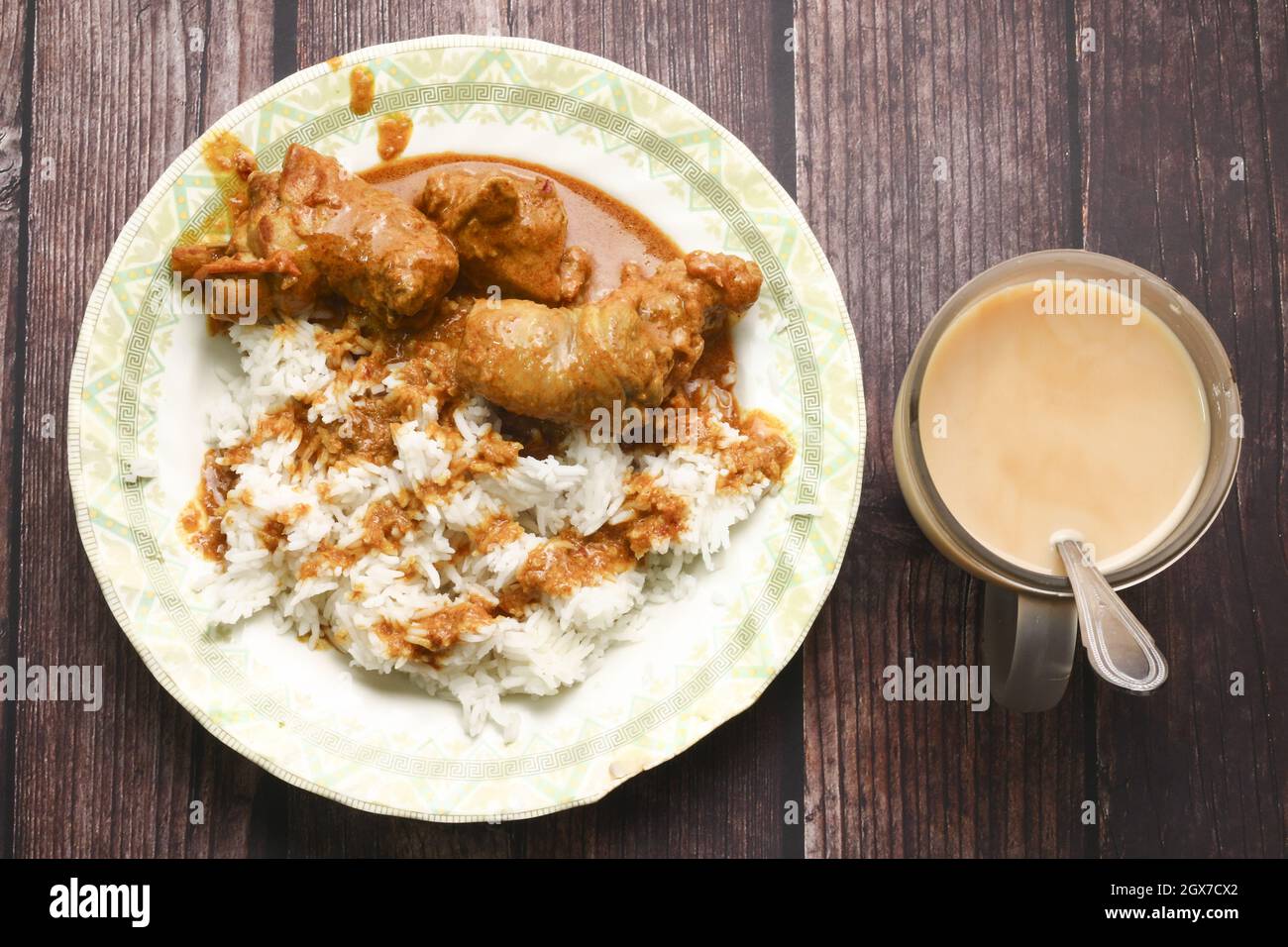 Top-view of a traditional meal of chicken and rice on a rustic wooden ...