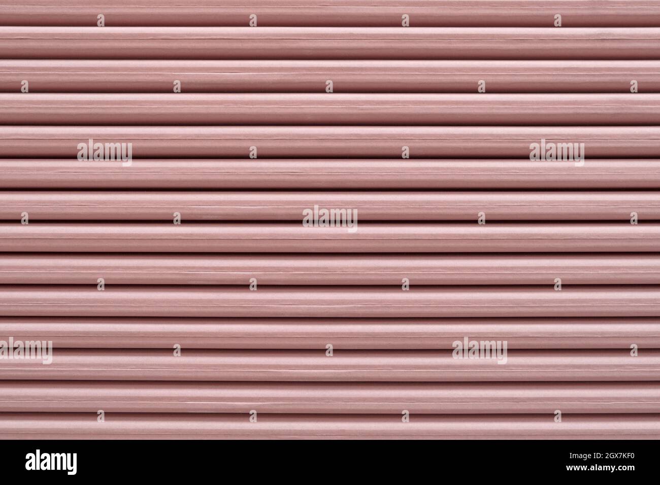 Close-up of red gypsum side edge stack of Plasterboard core with fiberglass mechanical strength and fire resistance increase. Gypsum cardboard surface Stock Photo