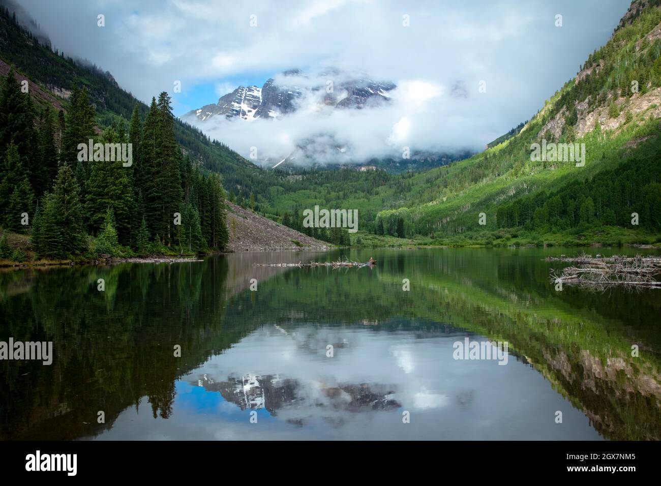 Cloudy mountain landscape of Colorado with a reflection of the Maroon Bells in summer Stock Photo