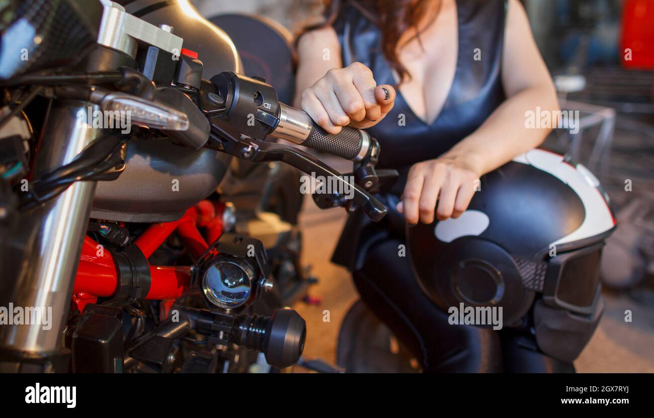 Biker girl in a leather dress at garage Stock Photo - Alamy Biker girl in a leather dress at garage Stock Photo - Alamy