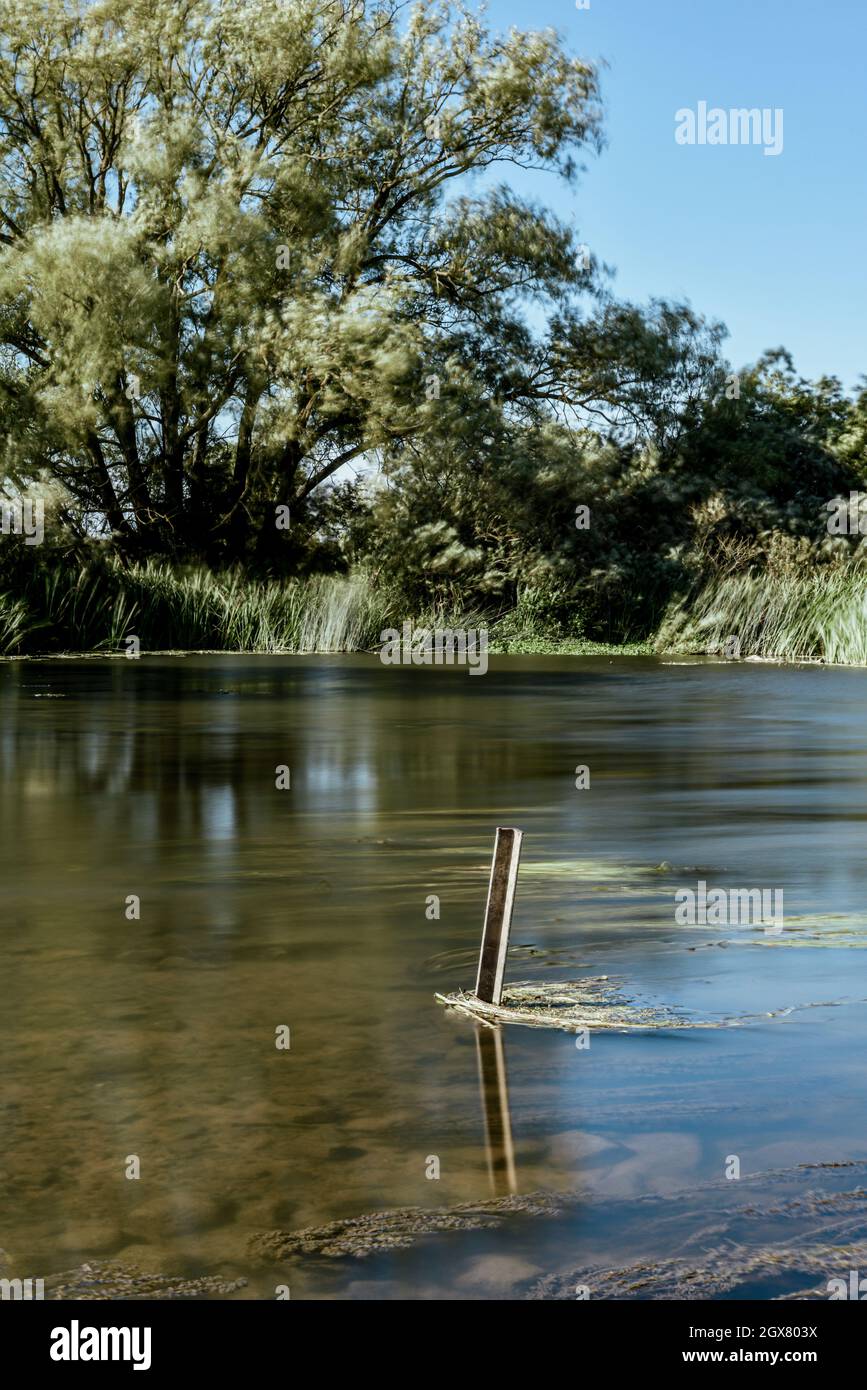 Calm water on a lake in a quiet countryside location Stock Photo