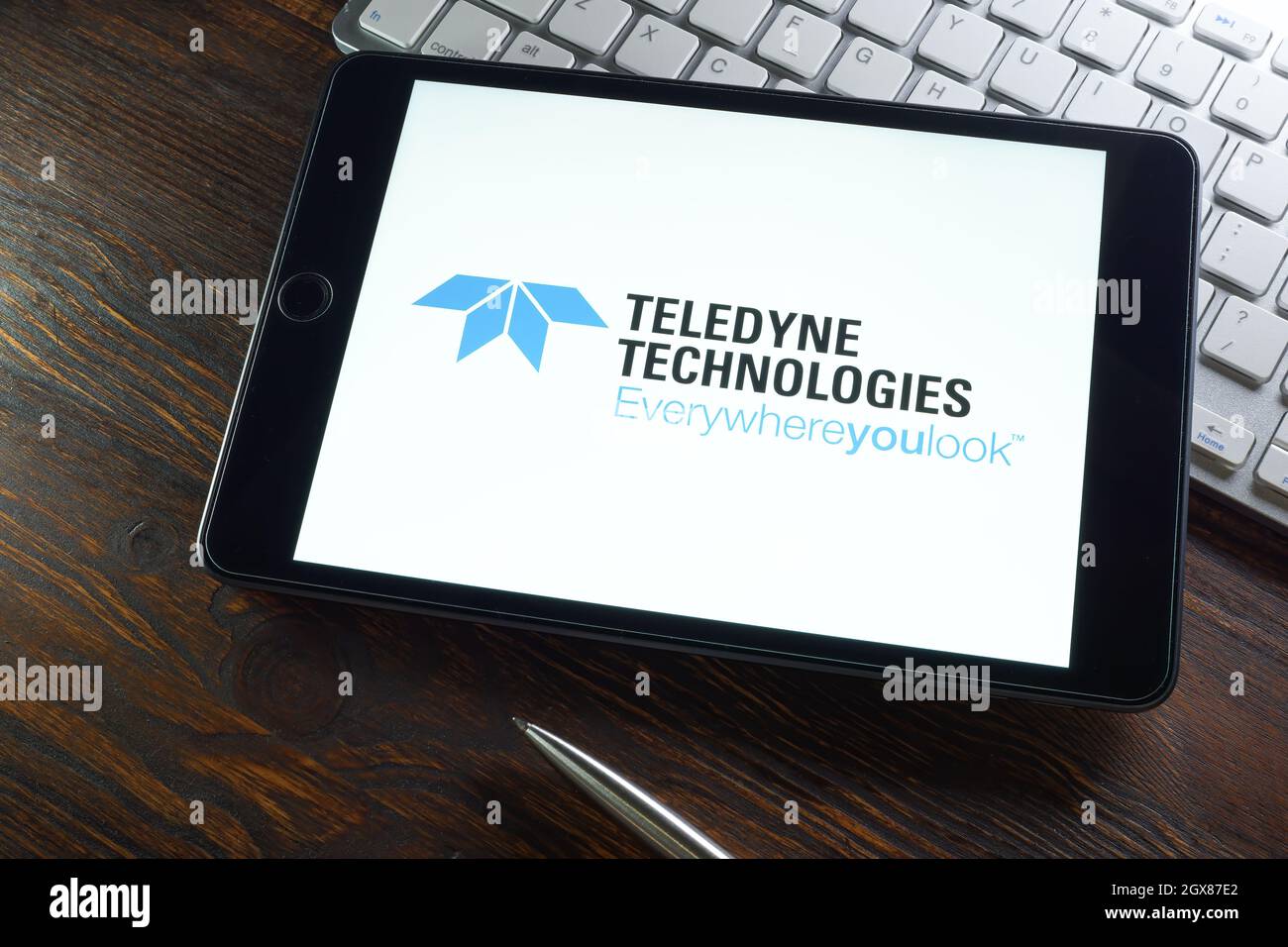 KYIV, UKRAINE - August 21, 2021. Teledyne Technologies International Corp logo and tablet. Stock Photo
