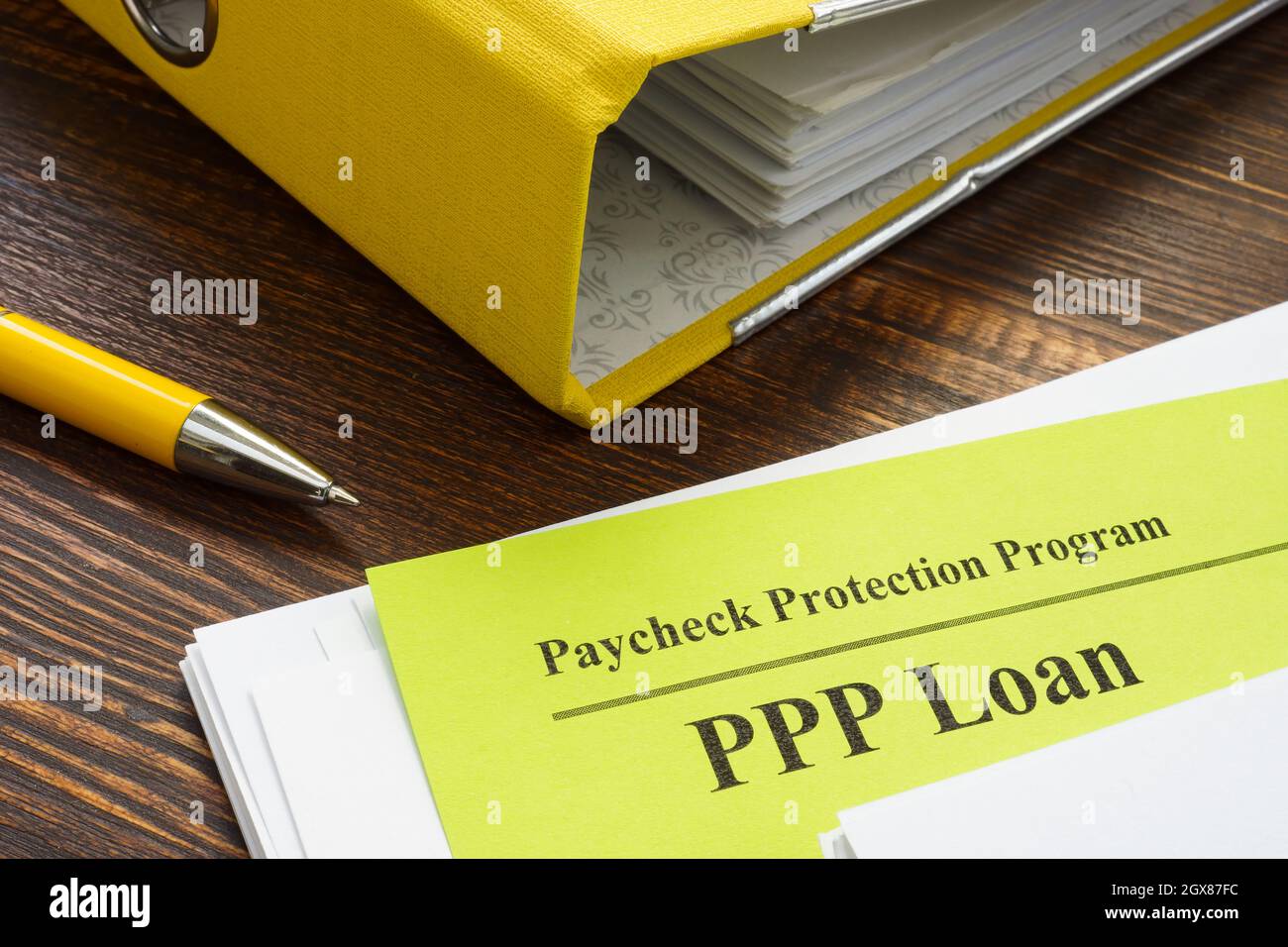 Paycheck Protection Program or PPP loan papers and yellow folder. Stock Photo