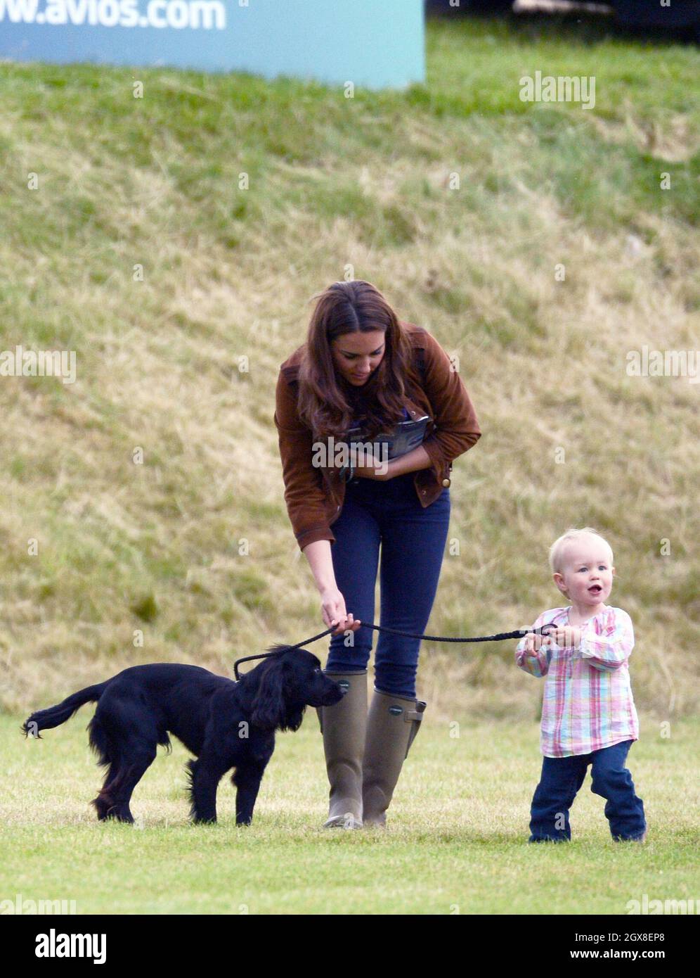 Catherine, Duchess of Cambridge relaxes with her dog Lupo and toddler