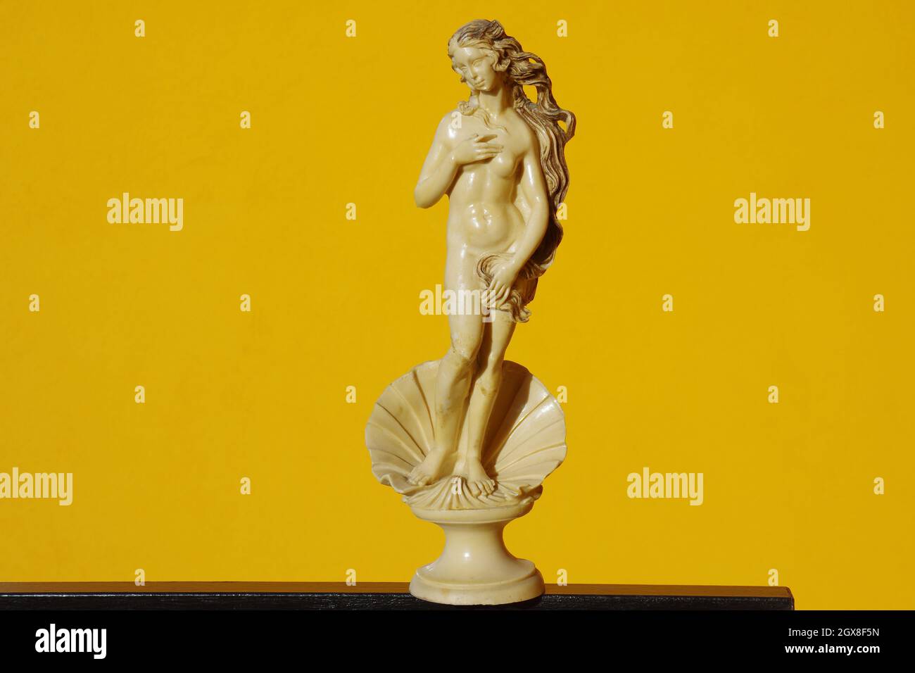 Scale reproduction after restoration of the statue representing the Birth of Venus by Botticelli on an orange background Stock Photo