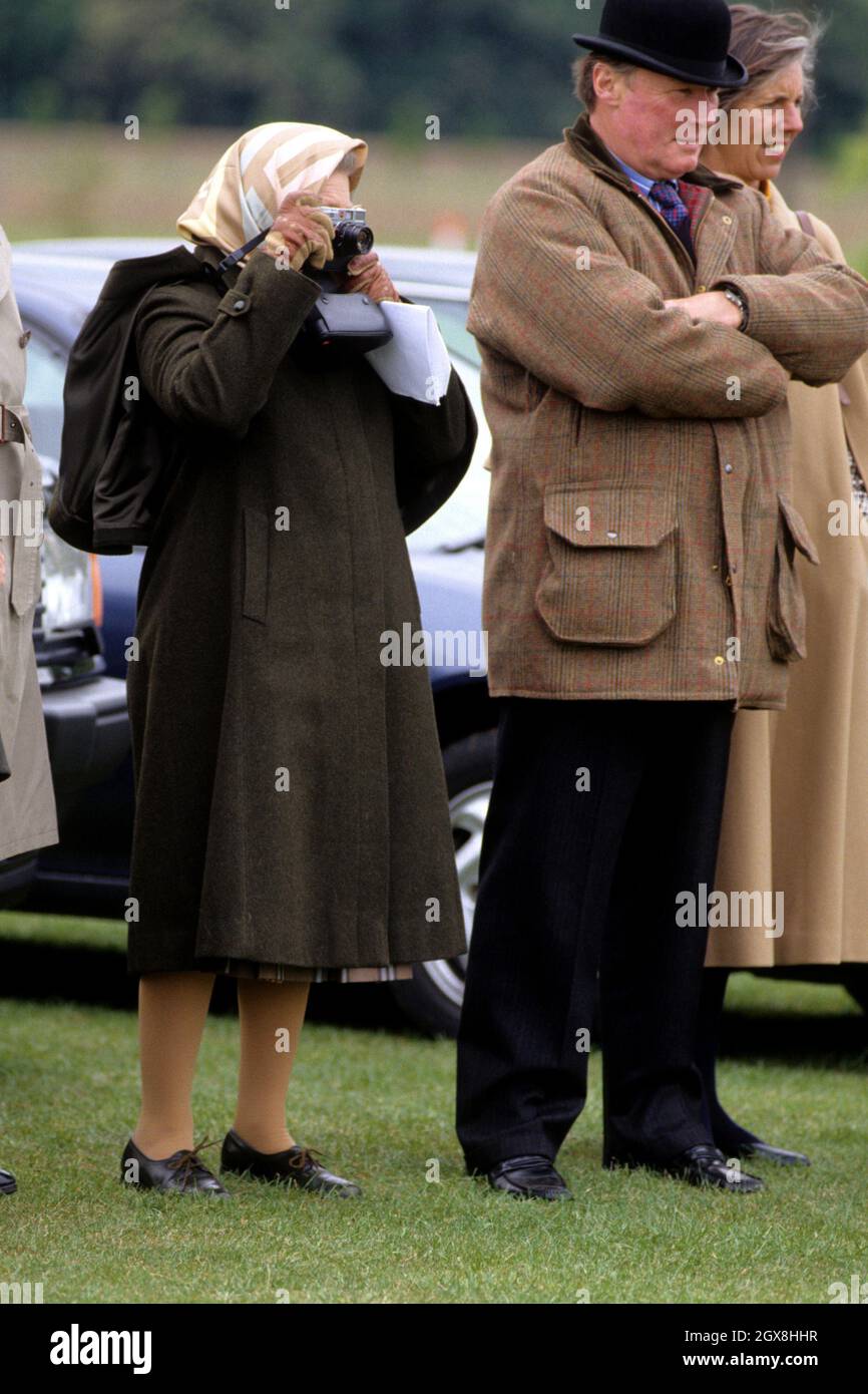 Queen Elizabeth II and Horse Trainer Howard Johnson attending the