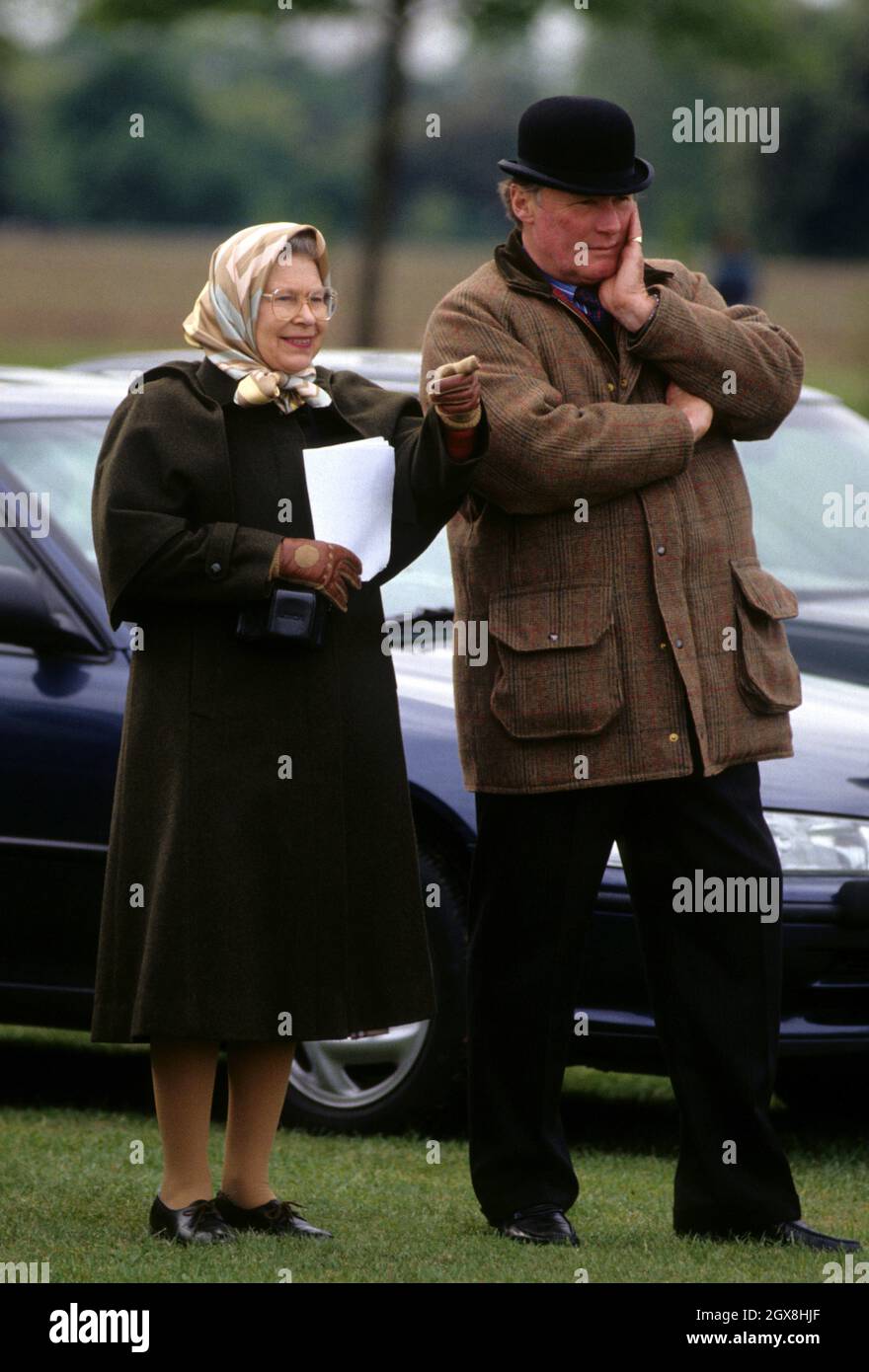 Queen Elizabeth II and Horse Trainer Howard Johnson attending the