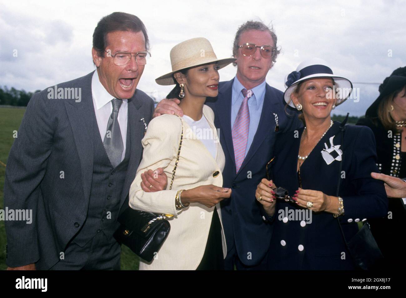 Roger Moore with Michael Caine and their partners Shakira Caine (r) and Luisa Mattioli (r). Stock Photo