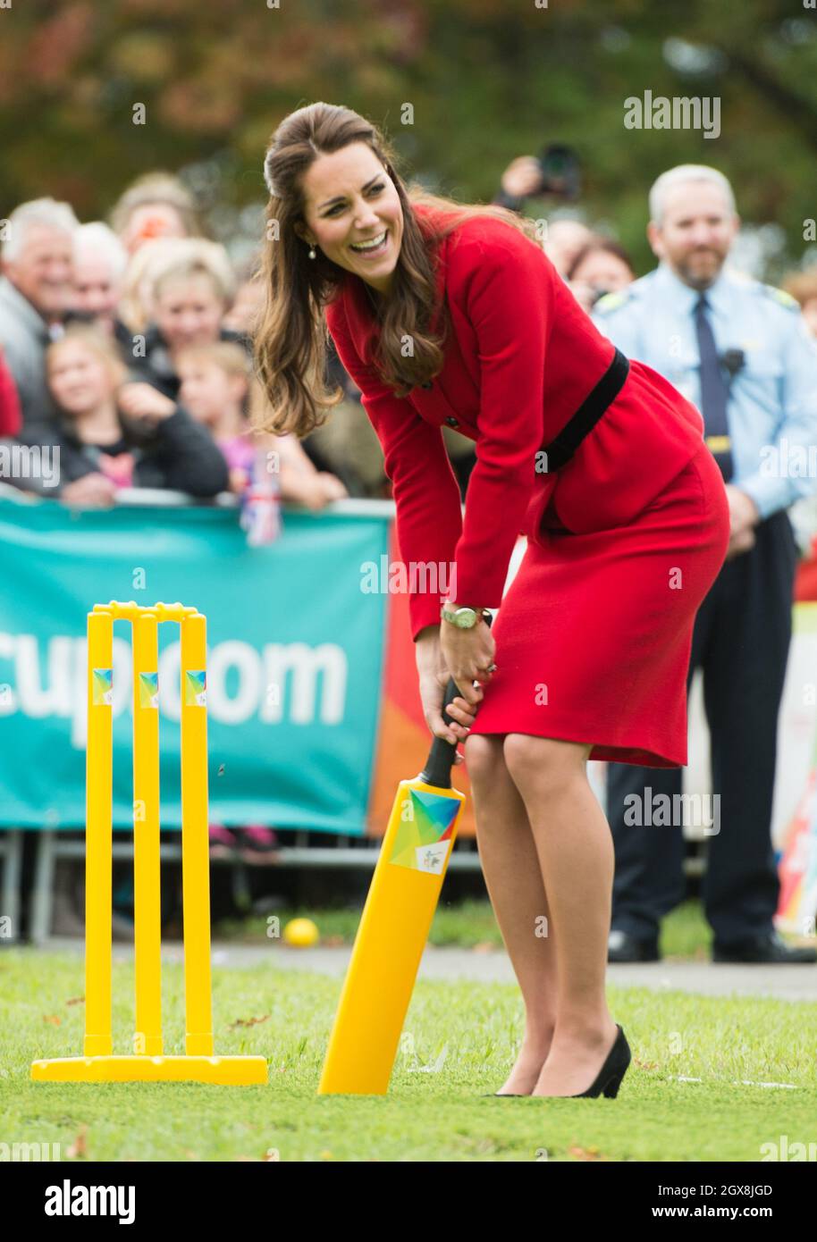 Catherine Duchess of Cambridge, wearing her red Luisa Spagnoli suit, bats during a game of cricket in a 2015 Cricket World Cup event in Christchurch, New Zealand on April 14, 2014.  Stock Photo