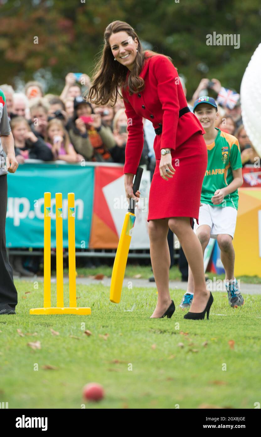 Catherine Duchess of Cambridge, wearing her red Luisa Spagnoli suit, bats during a game of cricket in a 2015 Cricket World Cup event in Christchurch, New Zealand on April 14, 2014.  Stock Photo