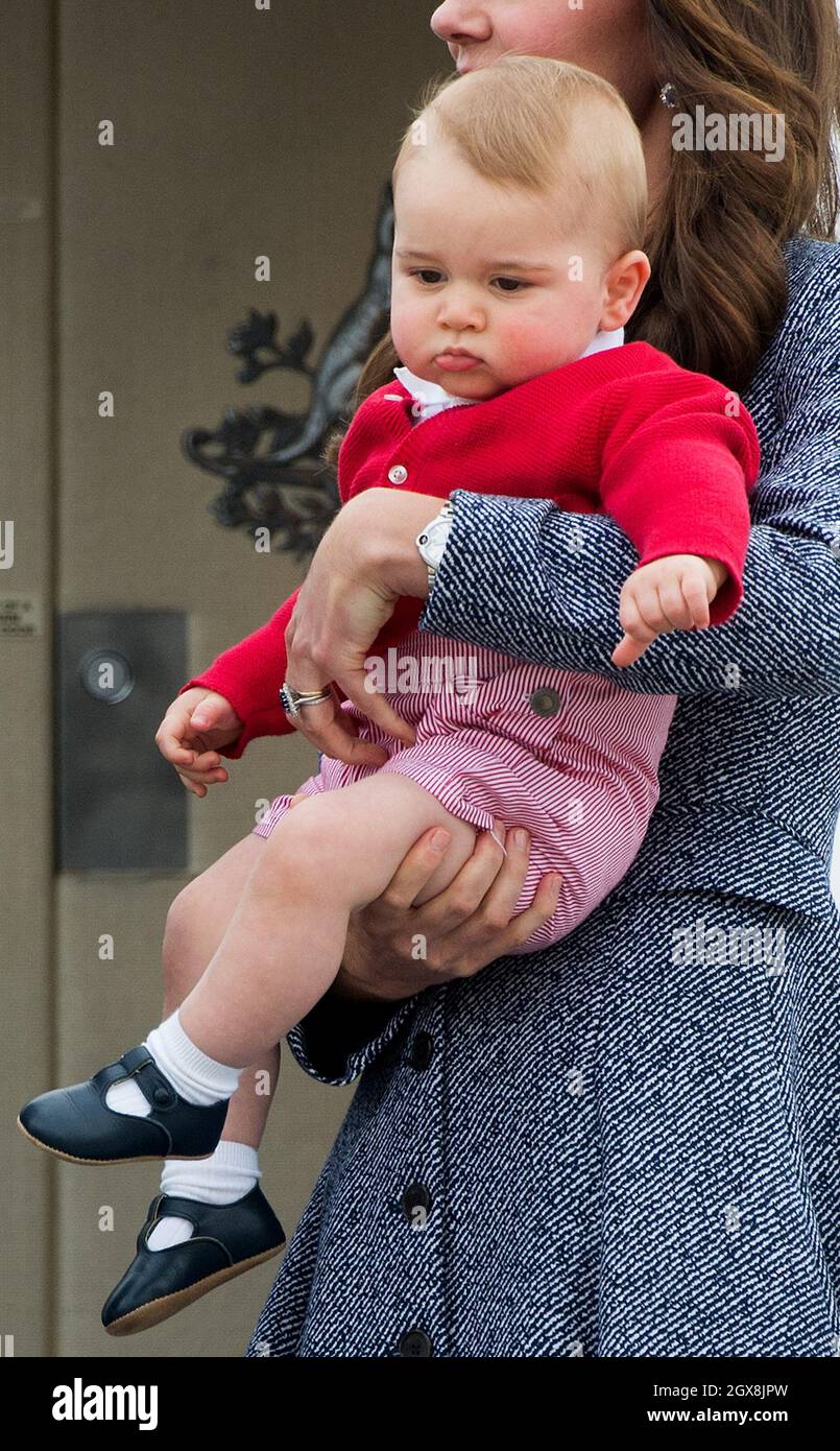 Catherine, Duchess of Cambridge holds baby Prince George as they leave Australia from Defence Establishment Fairbairn on April 25, 2014. Stock Photo