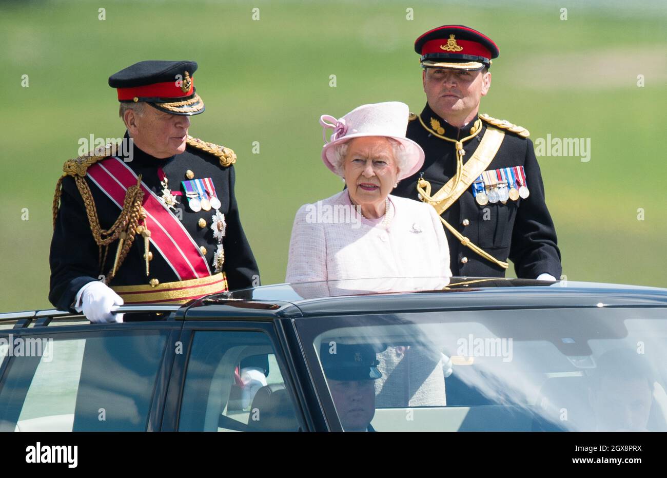 Queen Elizabeth II, Captain-General of The Royal Artillery, overseas a Review of The Royal Artillery from an open-topped Range Rover on the occasion of their Tercentenary at Knighton Down, Larkhill on May 26, 2016. Stock Photo