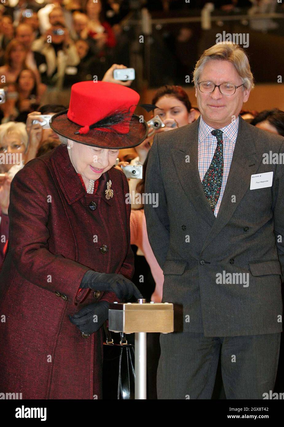 Queen Elizabeth ll presses a button to file a news story written by Reuters journalist Paul Majendie during a visit to the Reuters building in Canary Wharf, London. The Queen visited Reuters' new global headquarters and then sent a simulated despatch to mark the official opening of the building. Anwar Hussein/allactiondigital.com Stock Photo