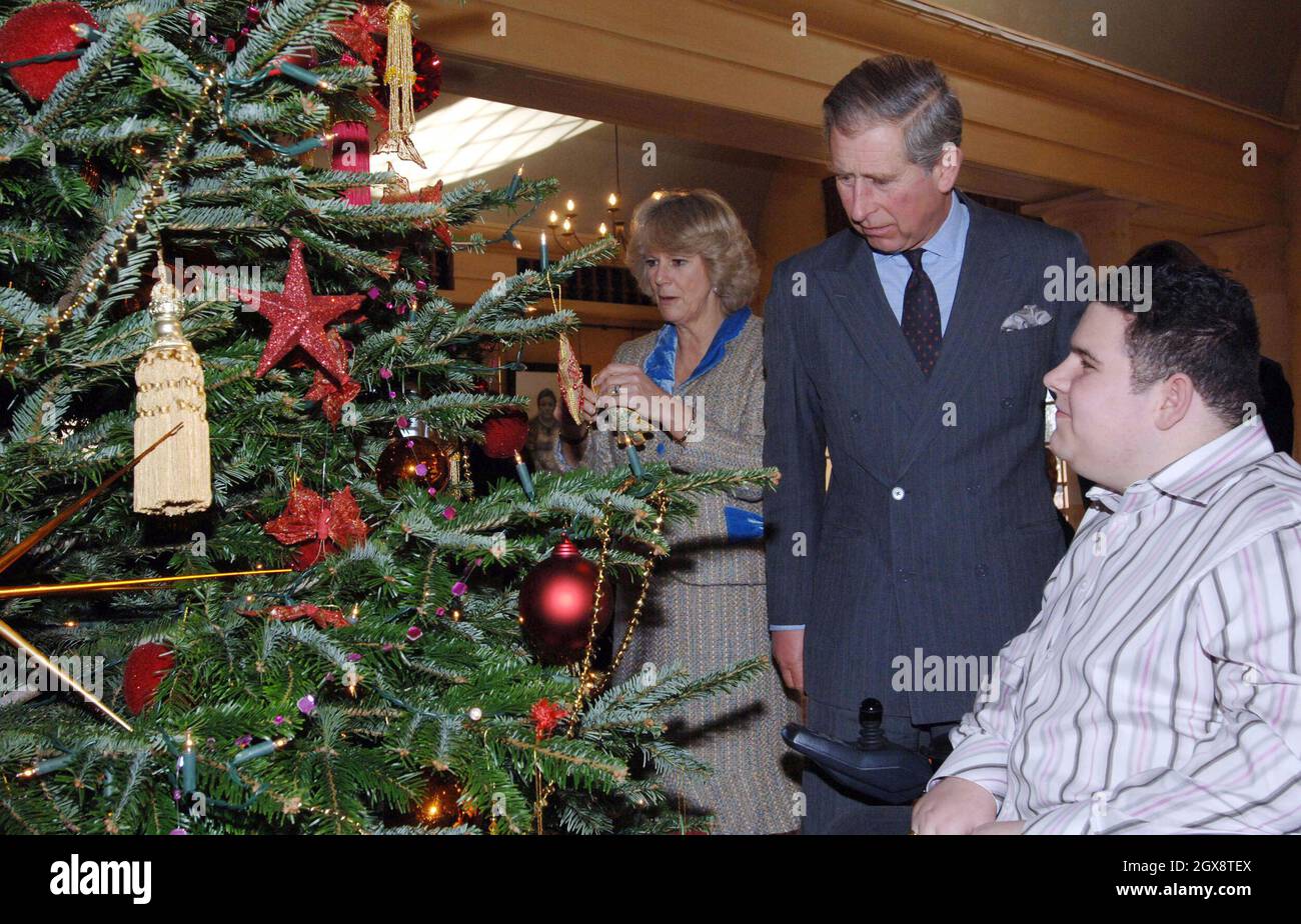 Charles, Prince of Wales and Camilla, Duchess of Cornwall are helped by 16 year old Sean Orchard from Neath to decorate the Christmas tree in the Orchard Room at Highgrove House, Tetbury, Gloucestershire. Ten excited youngsters were invited to the Prince's Highgrove estate in Gloucestershire to help the Royal couple decorate their Christmas tree. Charles and Camilla spent nearly an hour chatting and joking with the children, who were all being cared for at the Ty Hafan children's hospice in Barry, South Wales. Anwar Hussein/allactiondigital.com Stock Photo