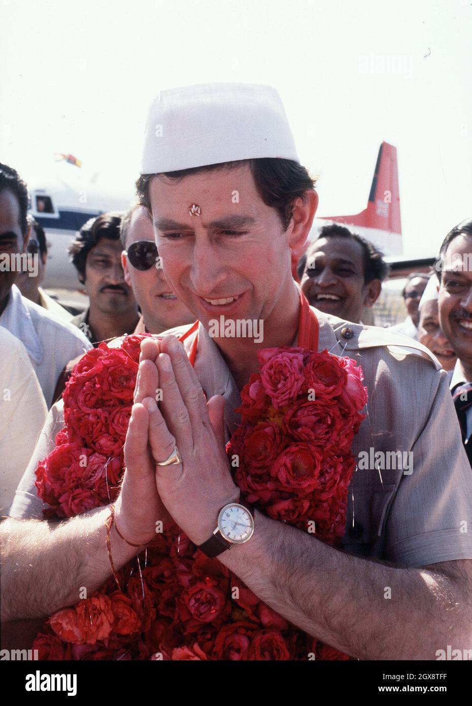 The Prince of Wales, appropriately garbed and garlanded, arrives in India in 1980. Anwar Hussein/allactiondigital.com  Stock Photo