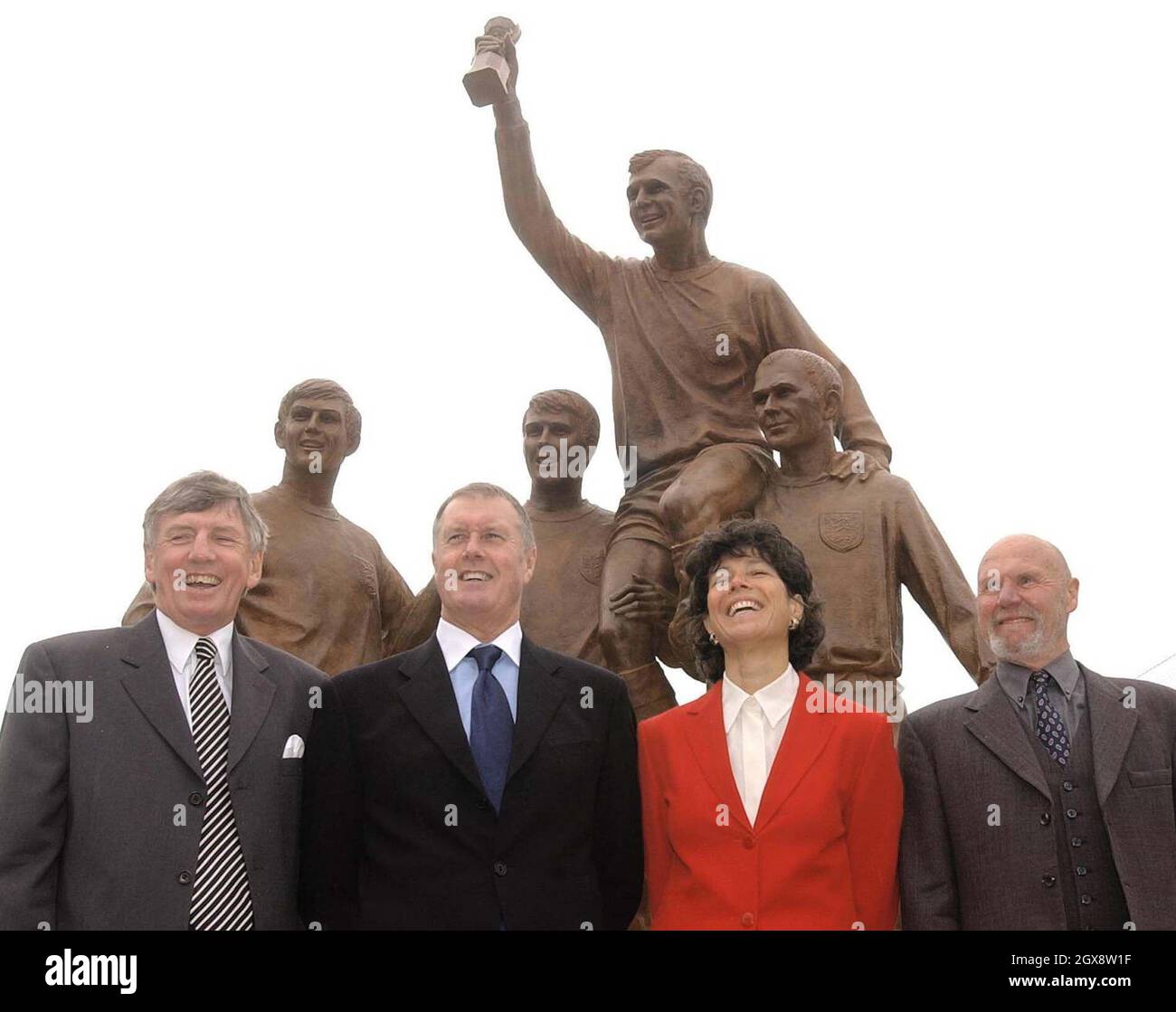 Former England footballers and members of the 1966 World Cup winning team, Martin Peters MBE (left), Sir Geoff Hurst MBE (second left), Ray Wilson MBE with Stephanie Moore, widow of England Captain Bobby Moore, stand in front of the statue unveiled by the Duke of York at West Ham's Upton Park ground in east London. Half length, suit  Â©Anwar Hussein/allaction.co.uk  Stock Photo