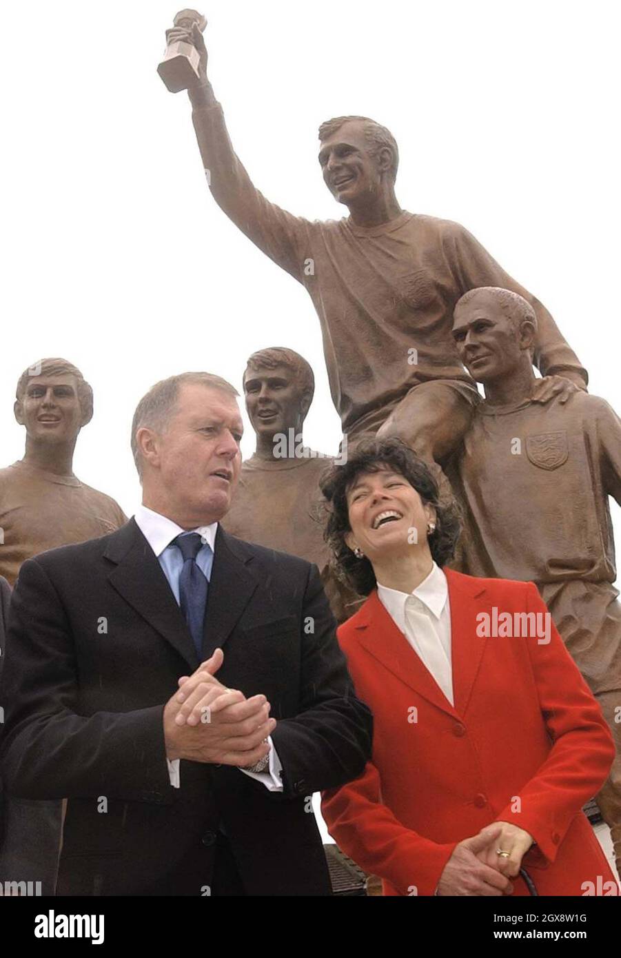 Former England footballer and member of the 1966 World Cup winning team Sir Geoff Hurst MBE, with Stephanie Moore, widow of England Captain Bobby Moore,stand in front of the statue unveiled by the Duke of York at West Ham's Upton Park ground in east London. Half length, suit  Â©Anwar Hussein/allaction.co.uk  Stock Photo