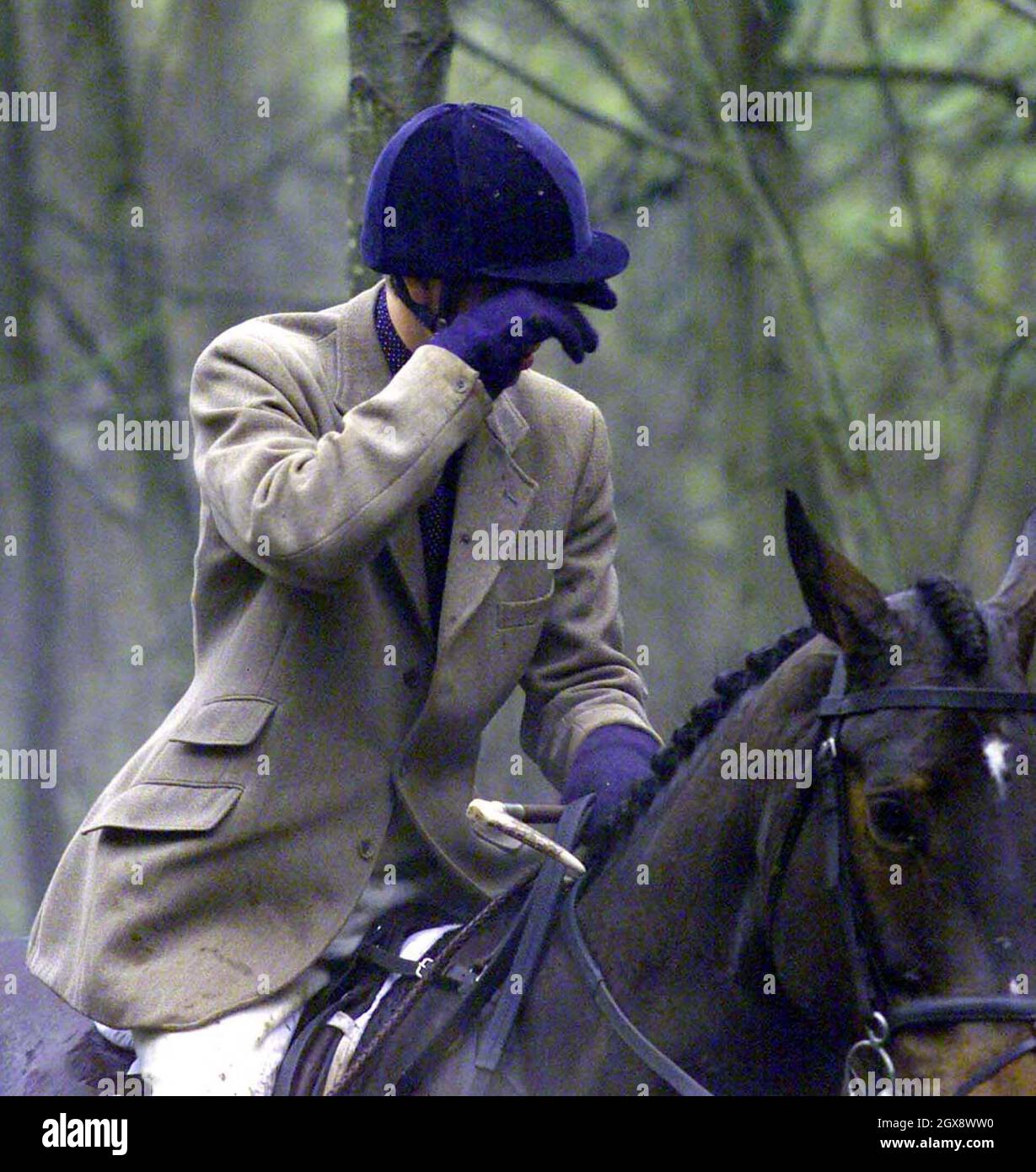 Prince William brushes some mud from his eye at the Beaufort hunt, Gloucester, England in 1999.  Photo.  Anwar Hussein   Stock Photo